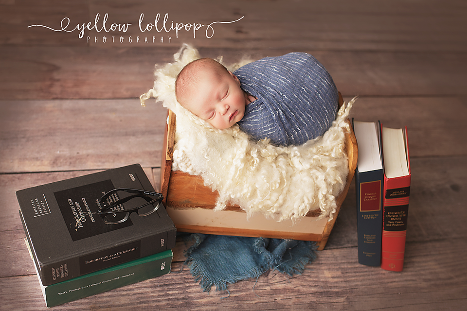 union county nj newborn photo session baby boy in a bed with law books