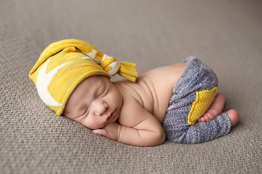 newborn photo session baby boy with hat and pants