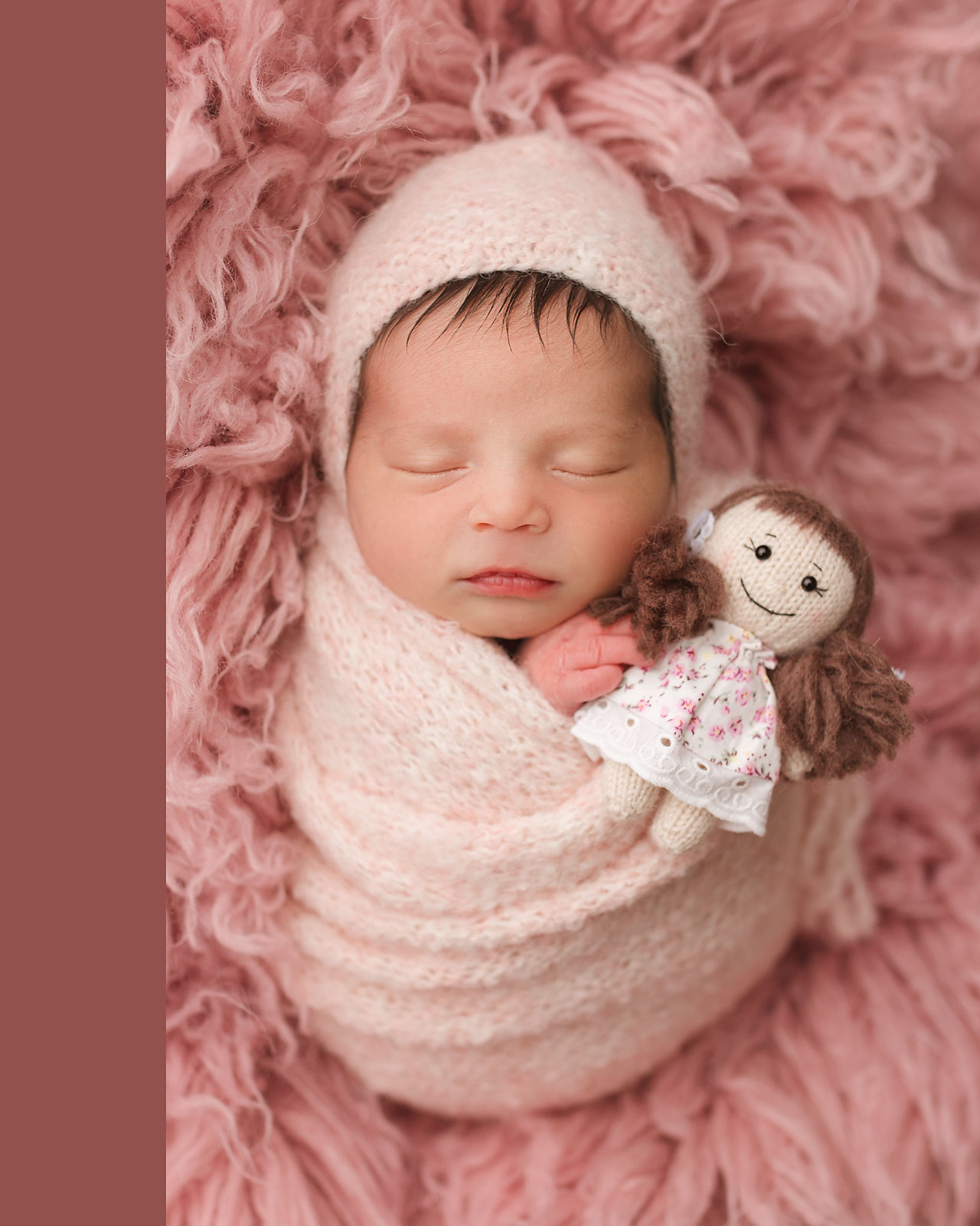 newborn baby holding a little doll photo hunterdon county nj