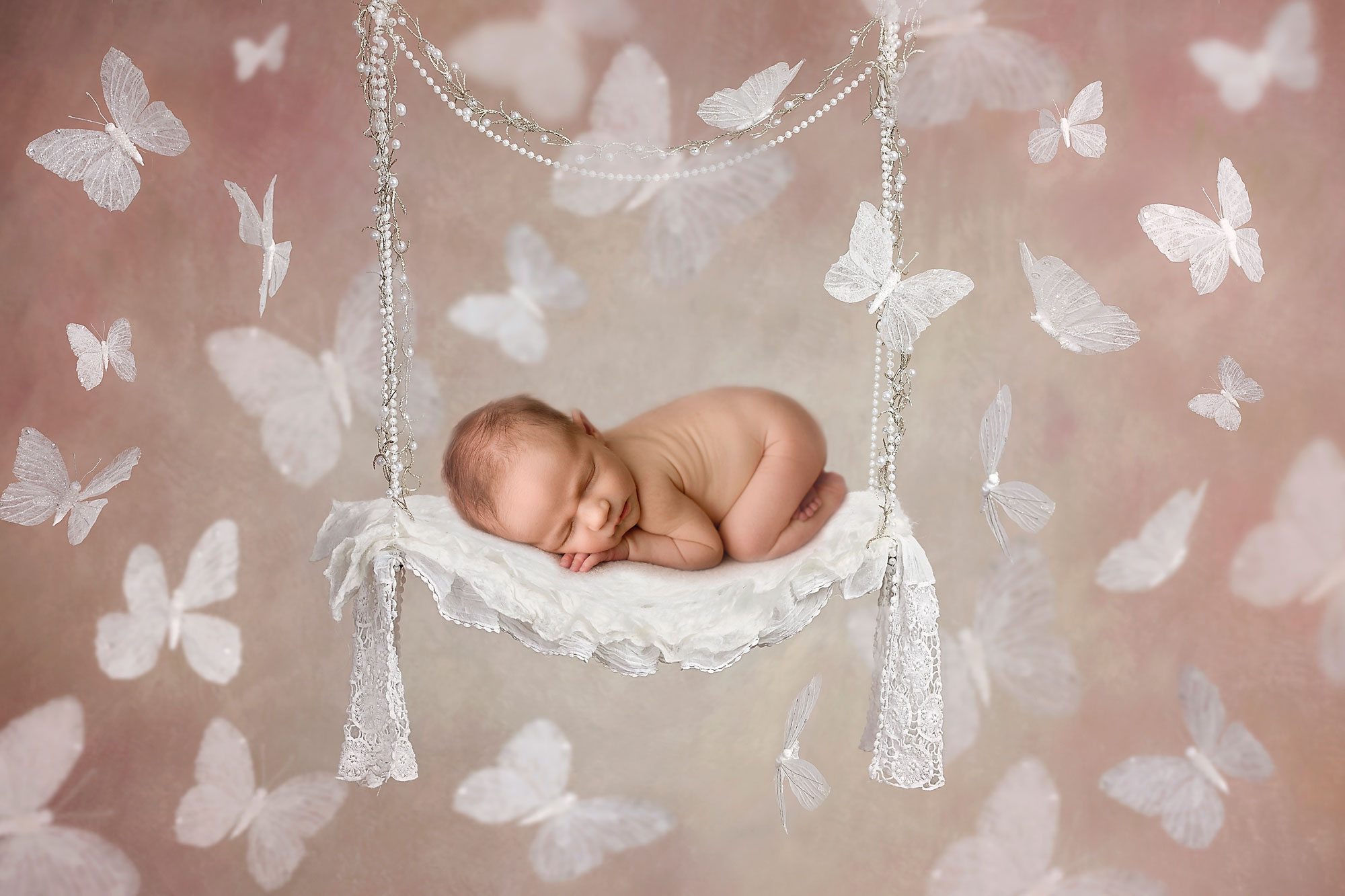 baby girl in a composite on a white swing newborn baby photographer morris county nj