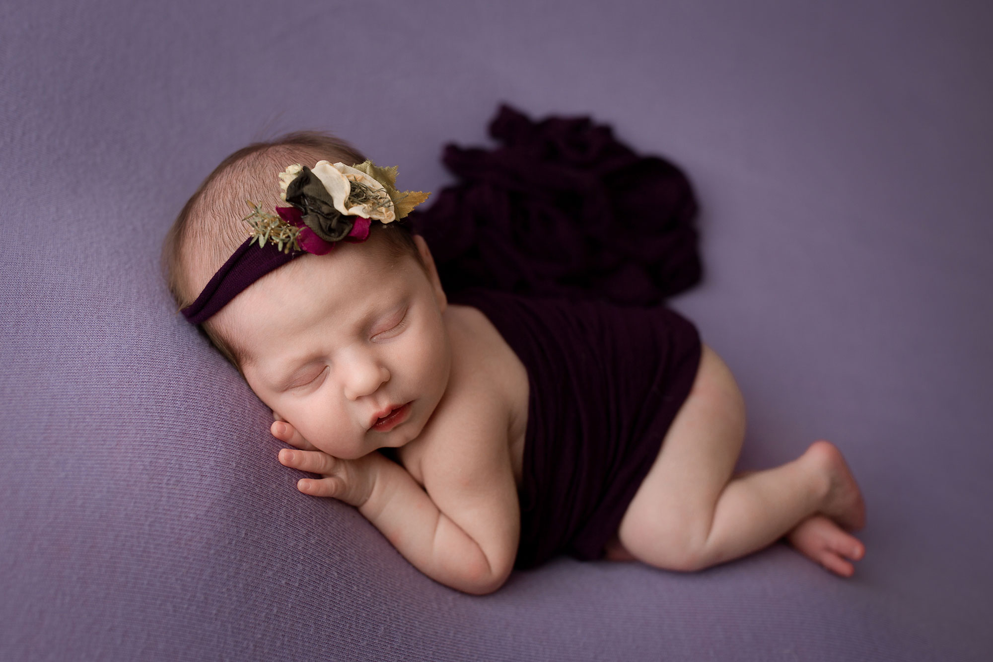newborn beanbag posing baby girl sleeping on a purple blanket newborn photography morris county nj yellow lollipop photography