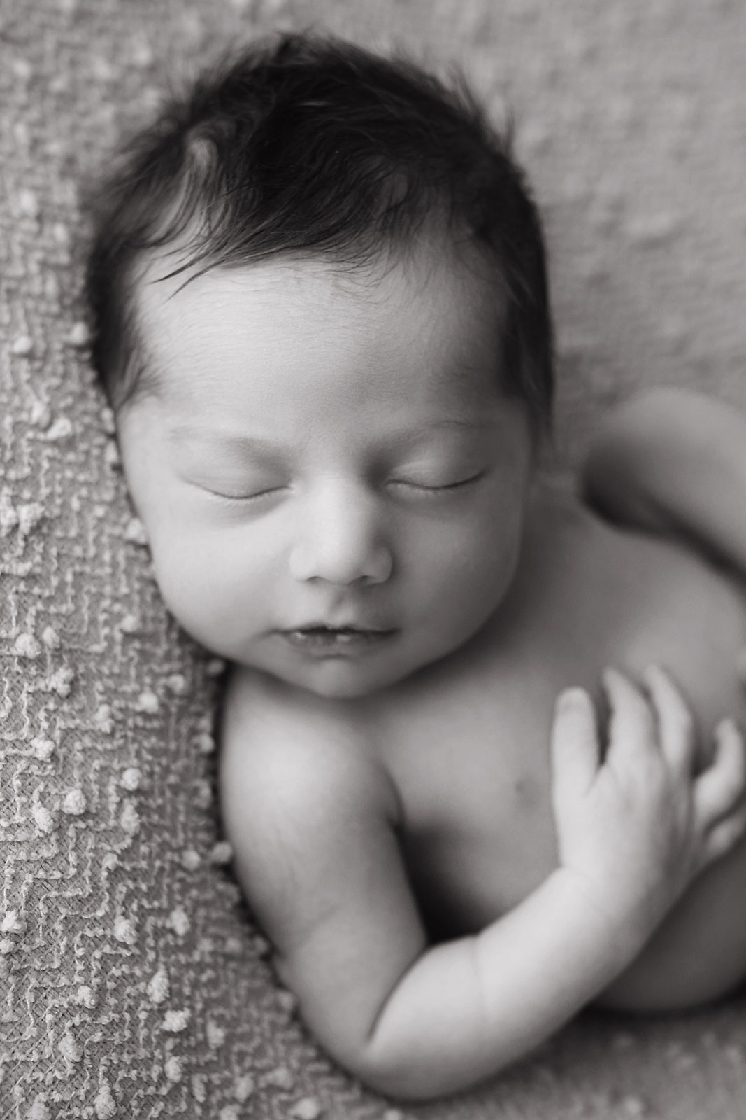 black and white photo of a sleeping baby newborn photography posing nj