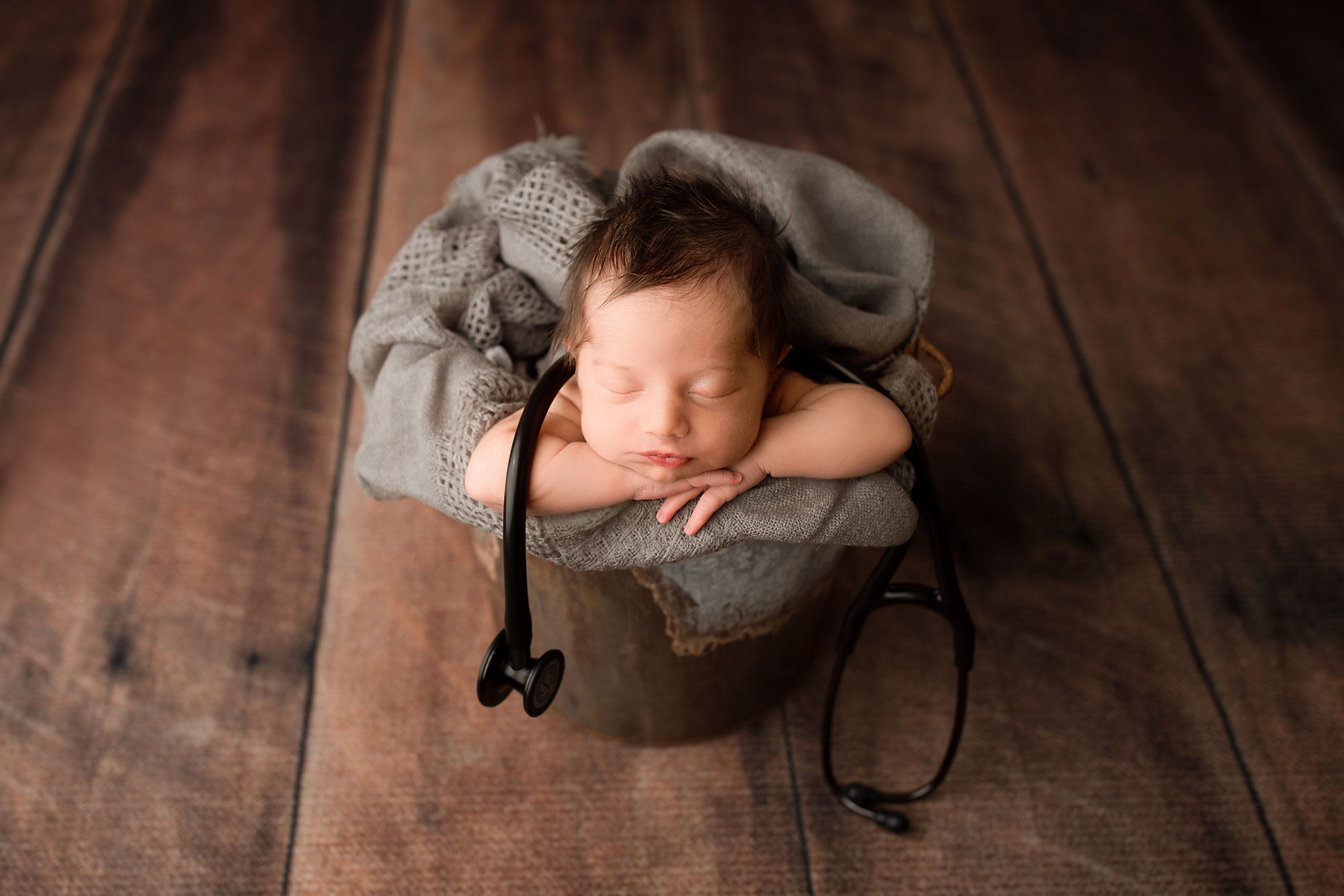 baby in a bucket newborn posing baby with a stethoscope 