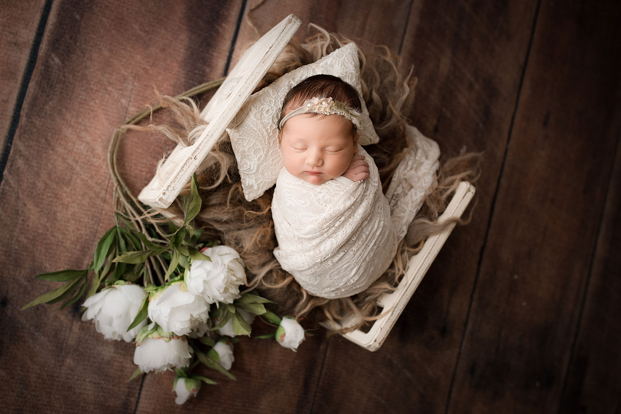 baby girl sleeping in a little bed with flowers baby photo session flemington nj