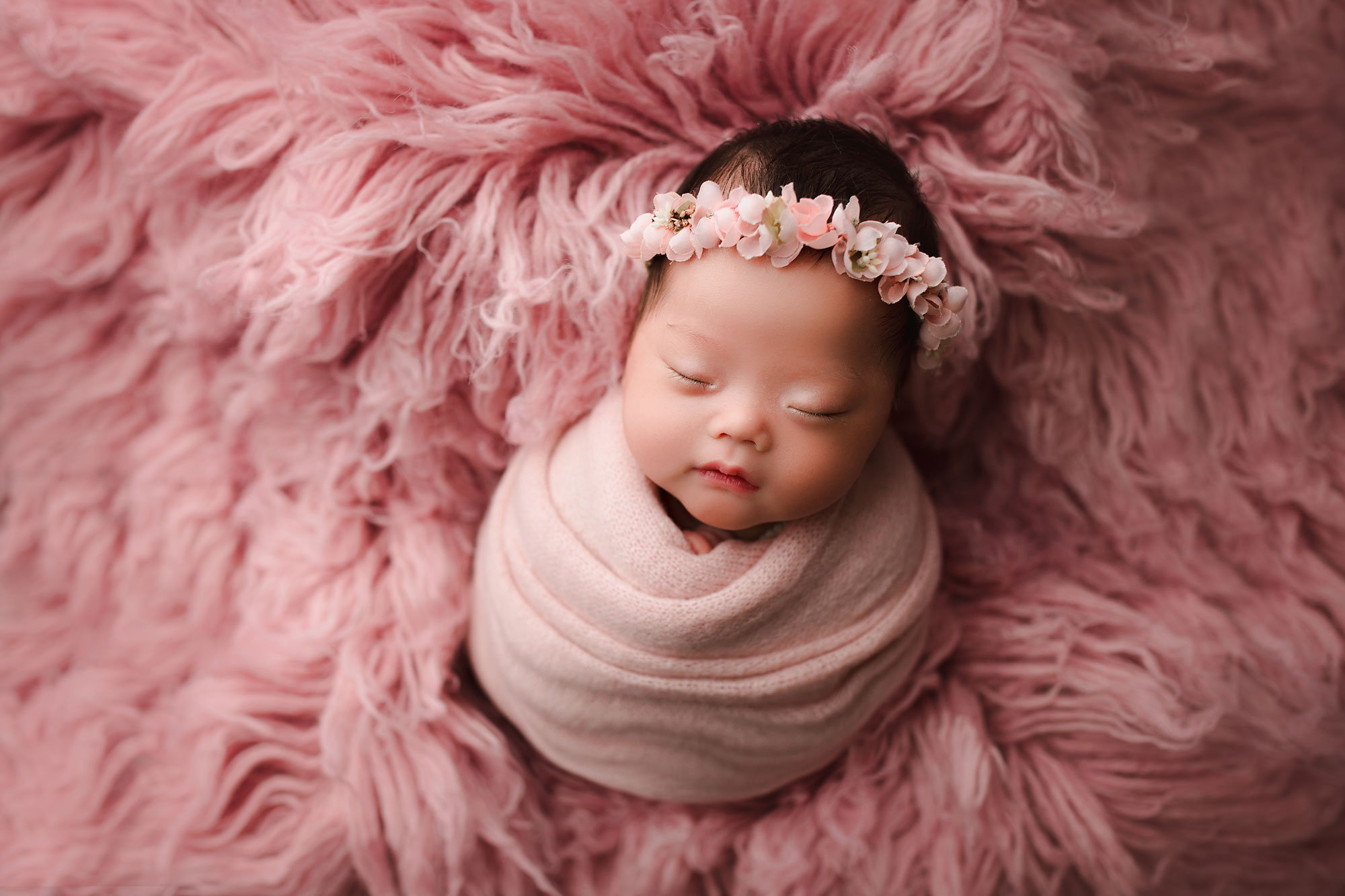 newborn girl swaddled on a pink flokati Bergen County NJ Newborn Photography 