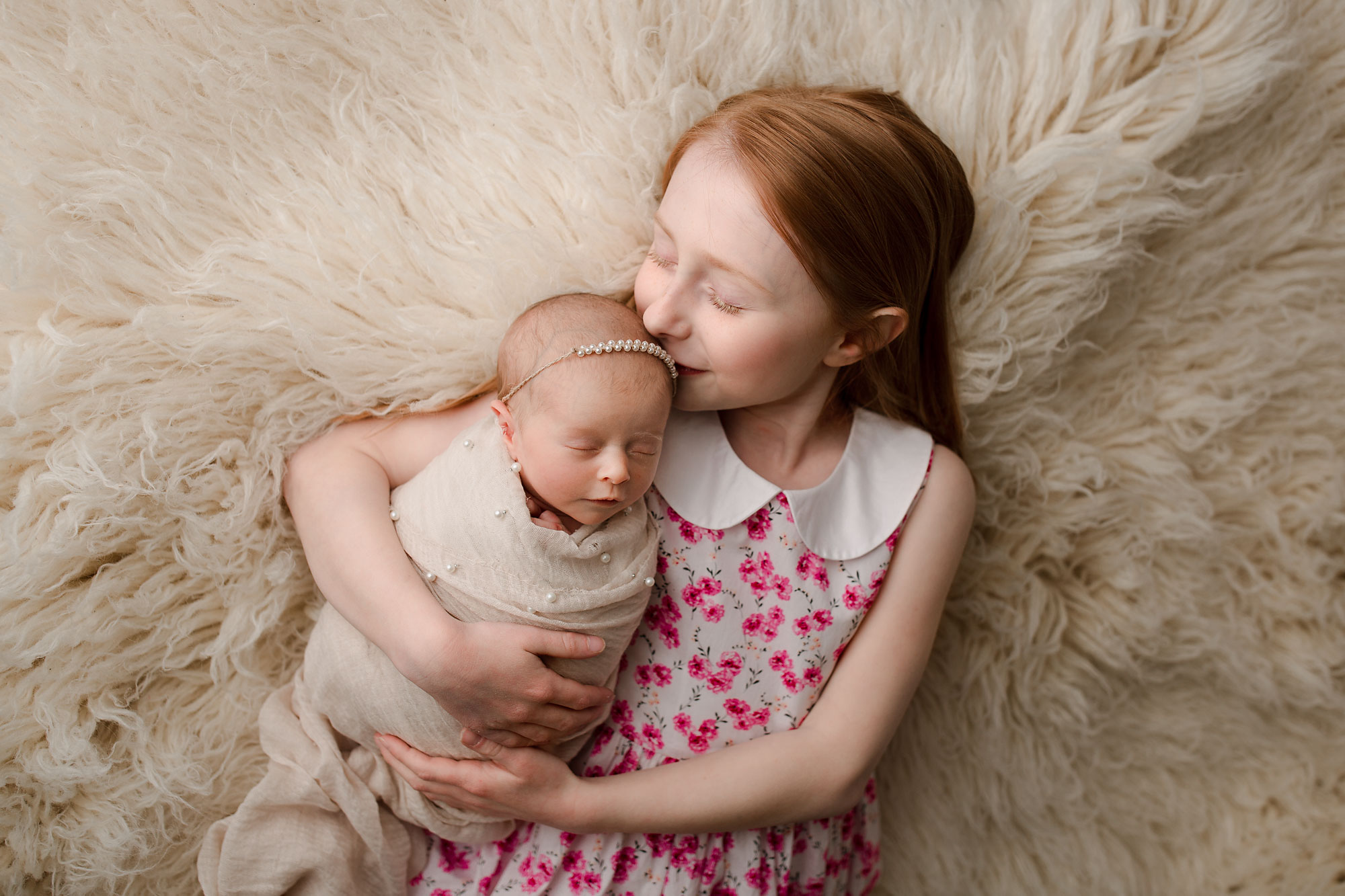 Readington NJ newborn photo session sister kissing a little baby 