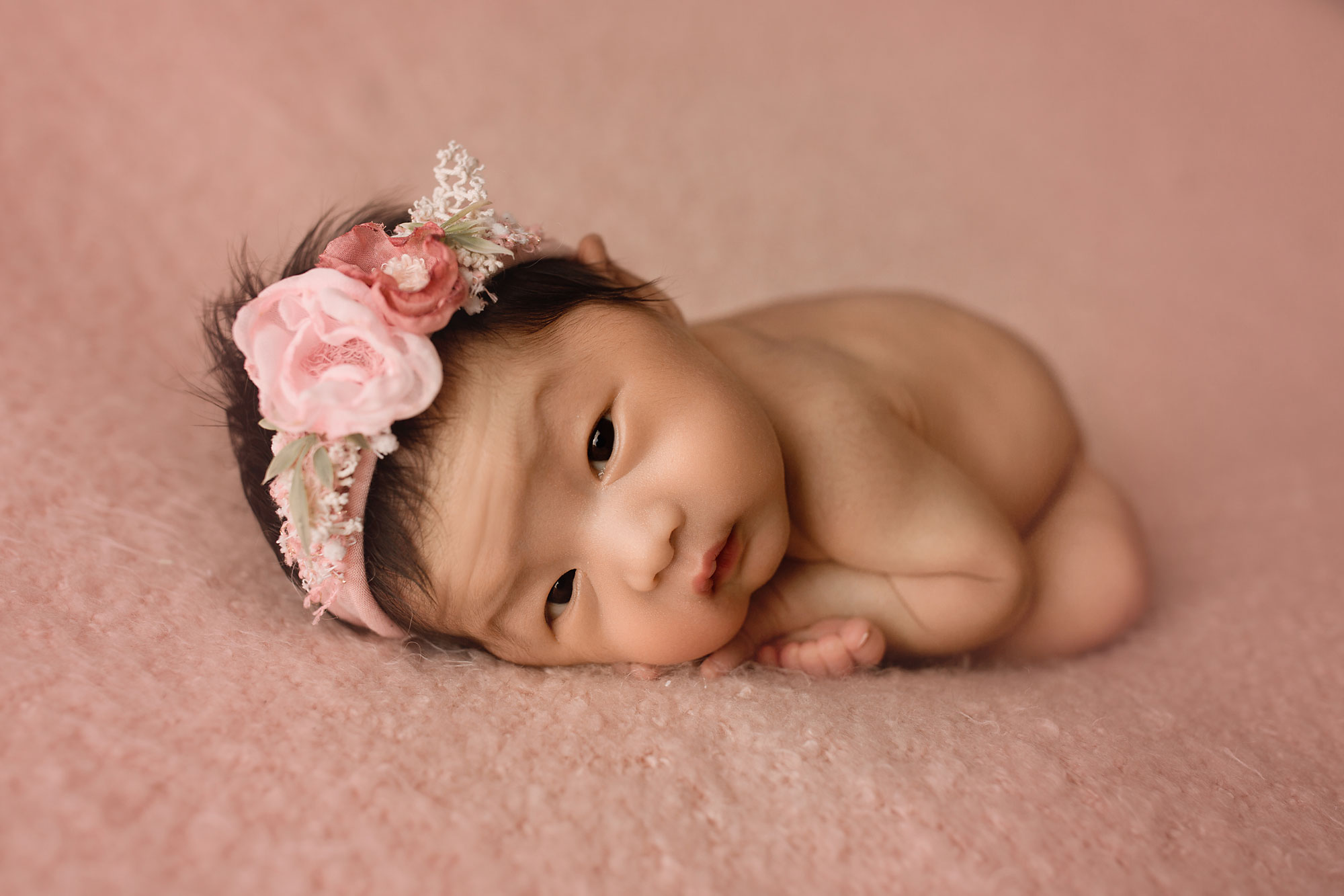 Newborn Photographer Bergen County NJ baby girl on a pink fabric