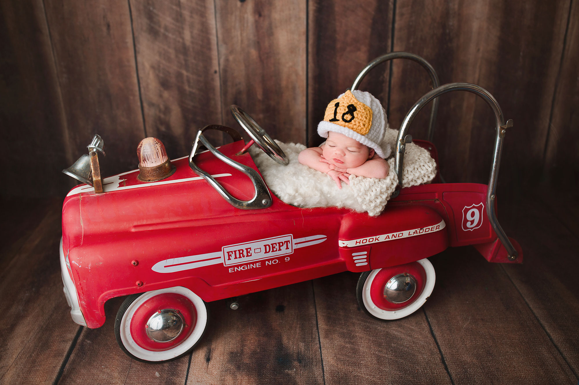 baby boy in a vintage fire truck baby photographer nj 