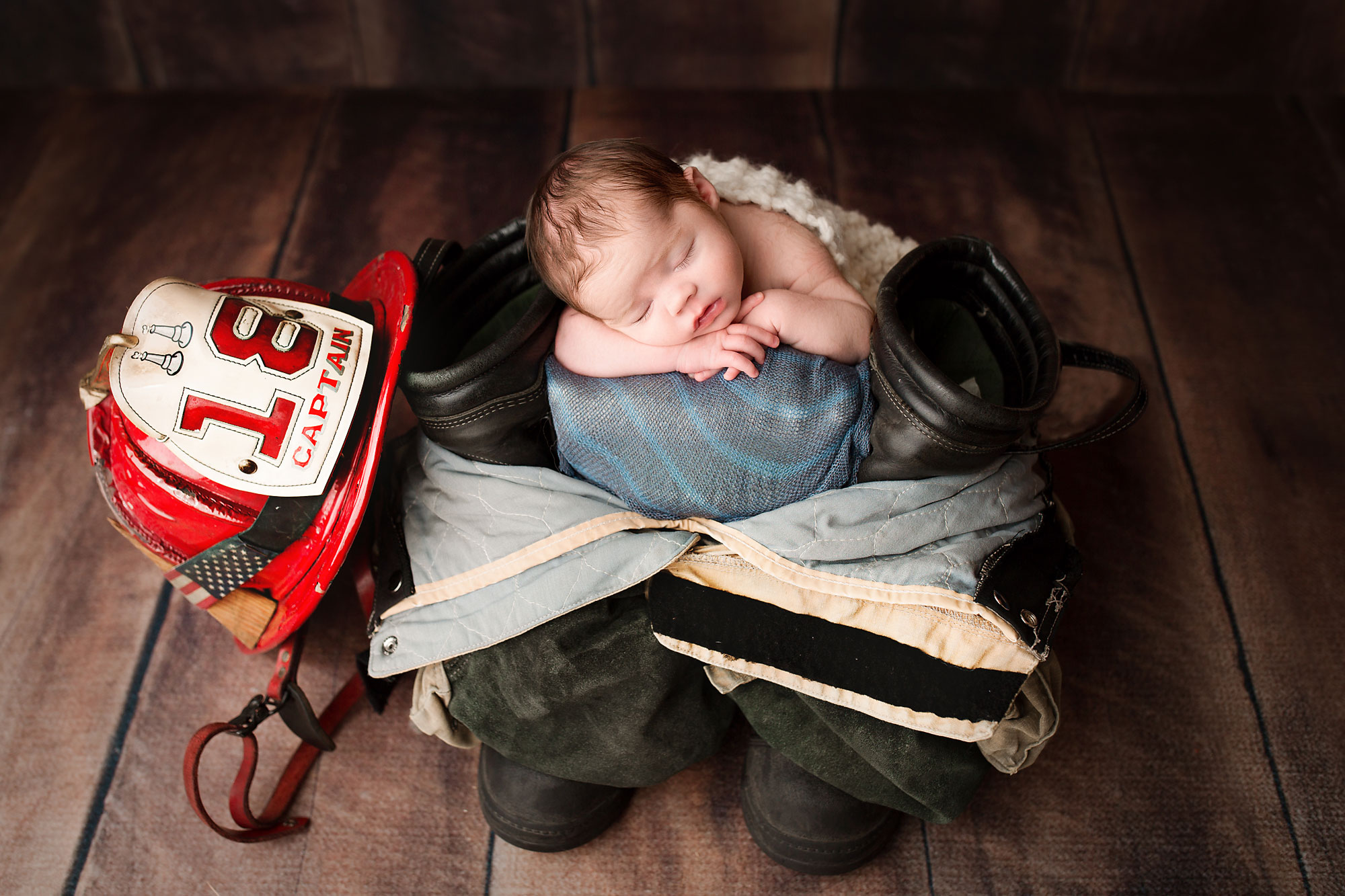 baby boy in daddys fireman gear nj newborn photographer
