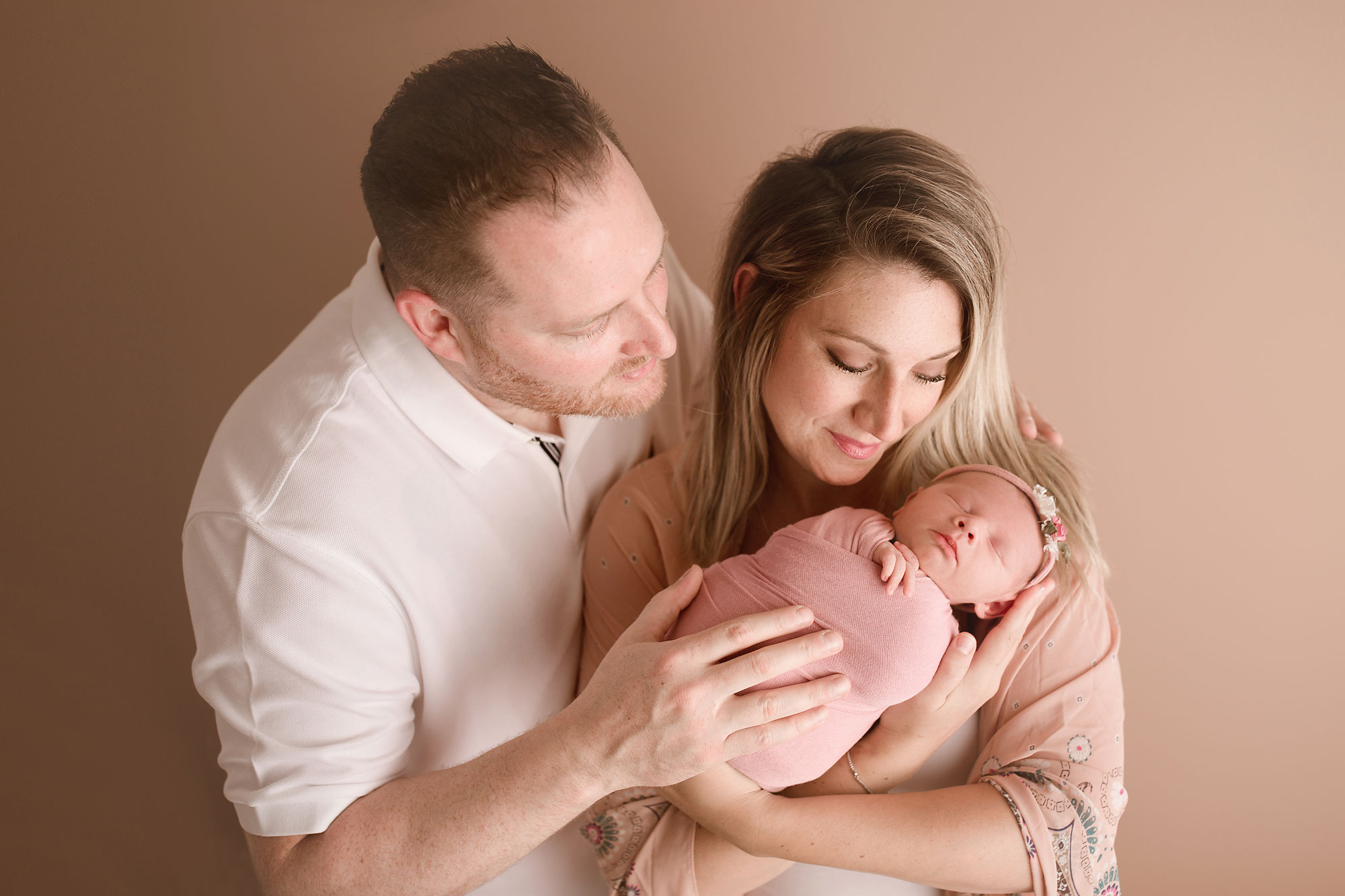 newborn and family photos Hunterdon County, parents cradling newborn girl