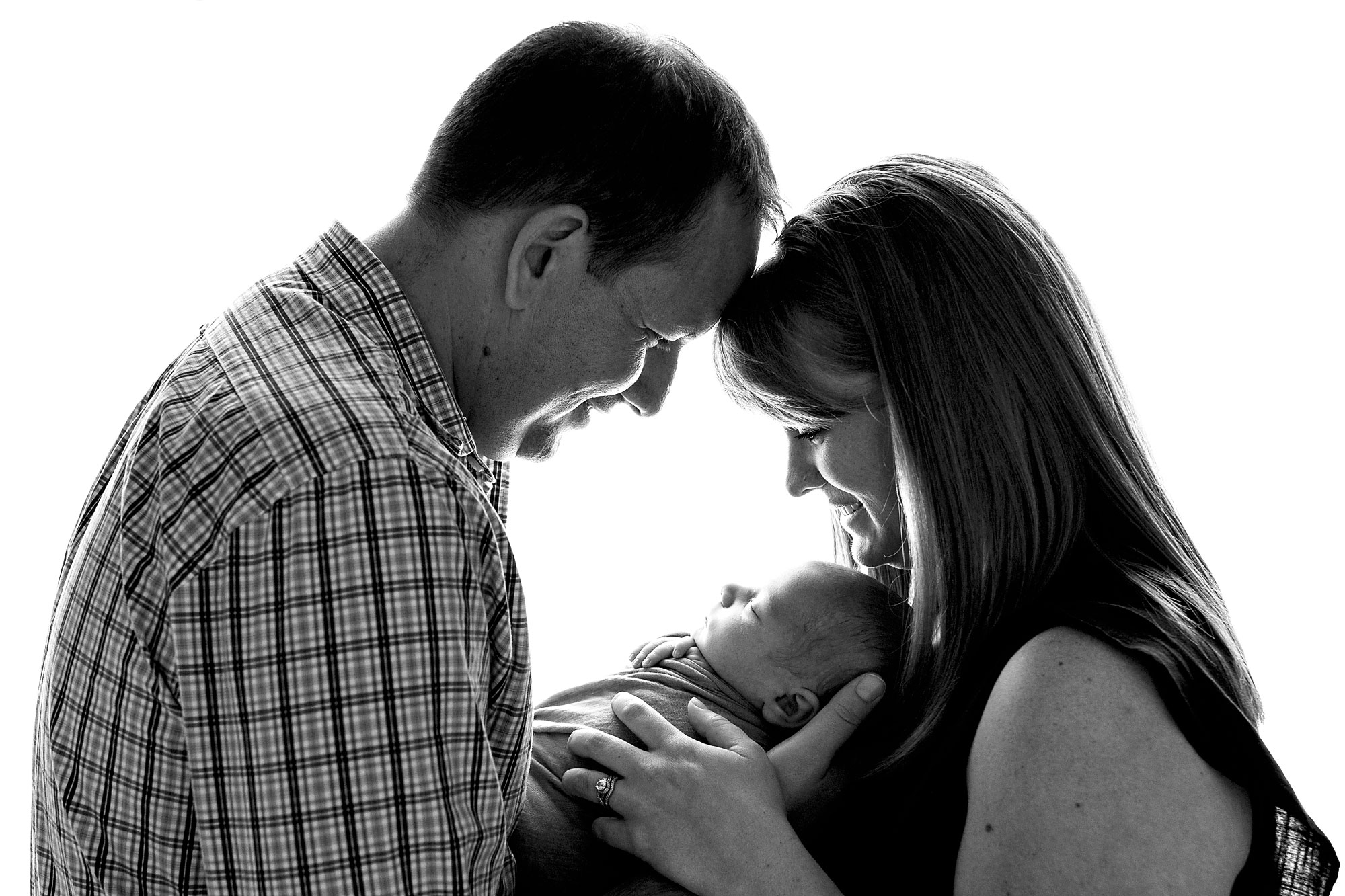 newborn and family photography new jersey, black and white image of parents touching foreheads while holding new baby