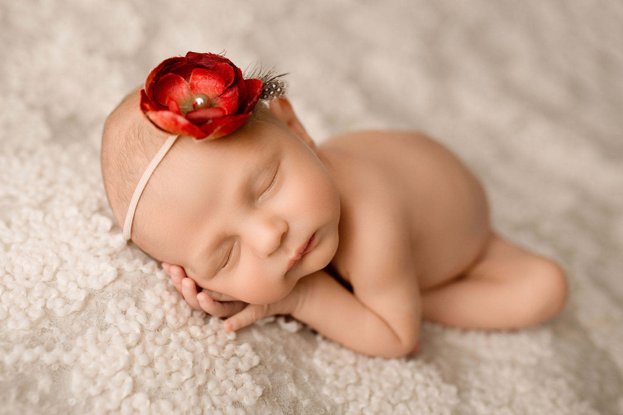 best baby photographers new jersey, naked baby girl asleep on white fabric with red flower headband