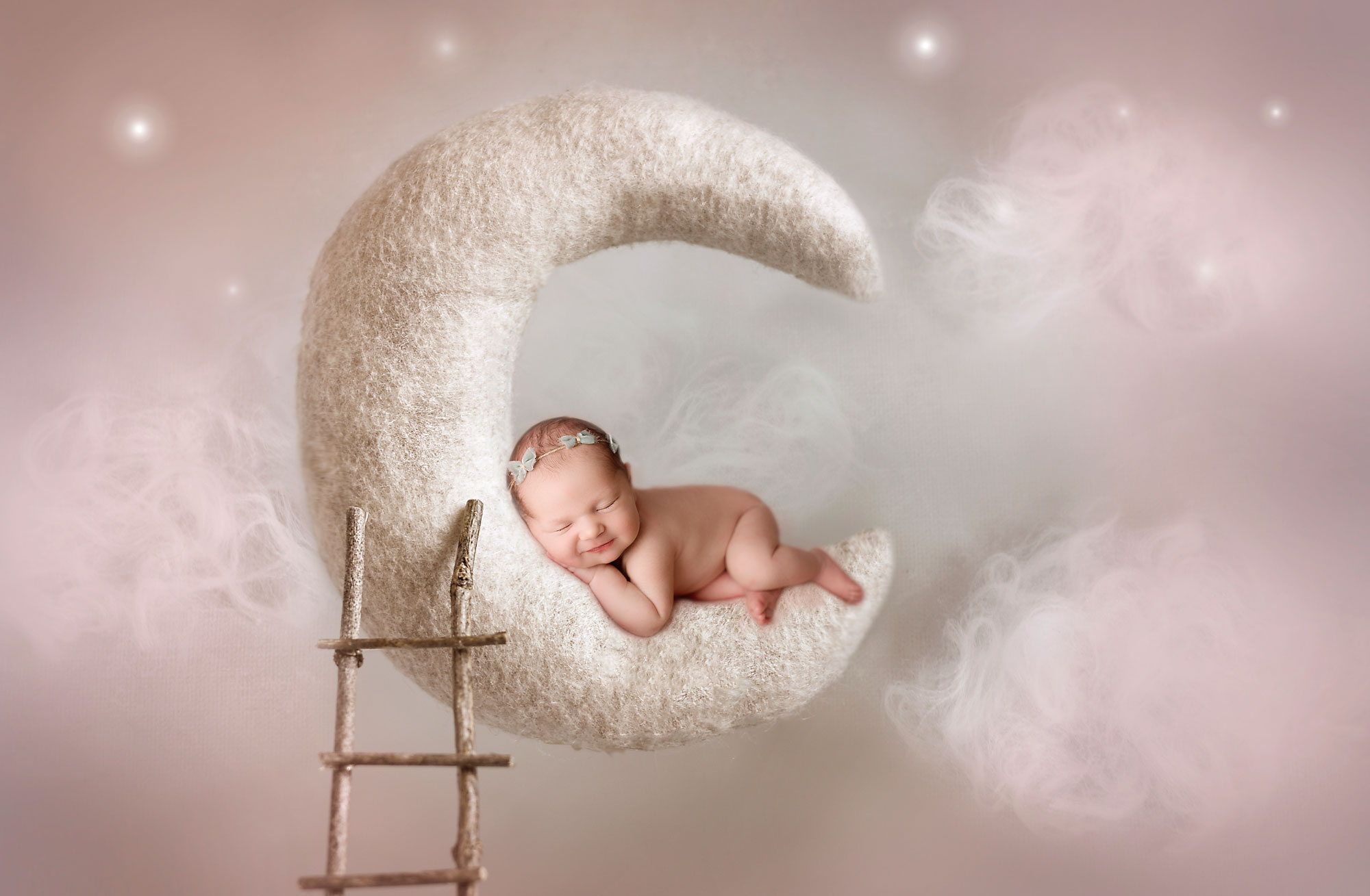 magical newborn photography nj, baby girl asleep on suspended moon with wooden ladder and starry sky backdrop