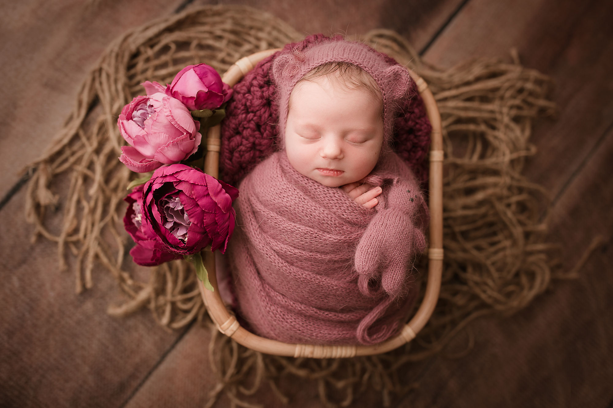 baby girl pictures nj, baby in yarn wrap and cap with teddy and flowers