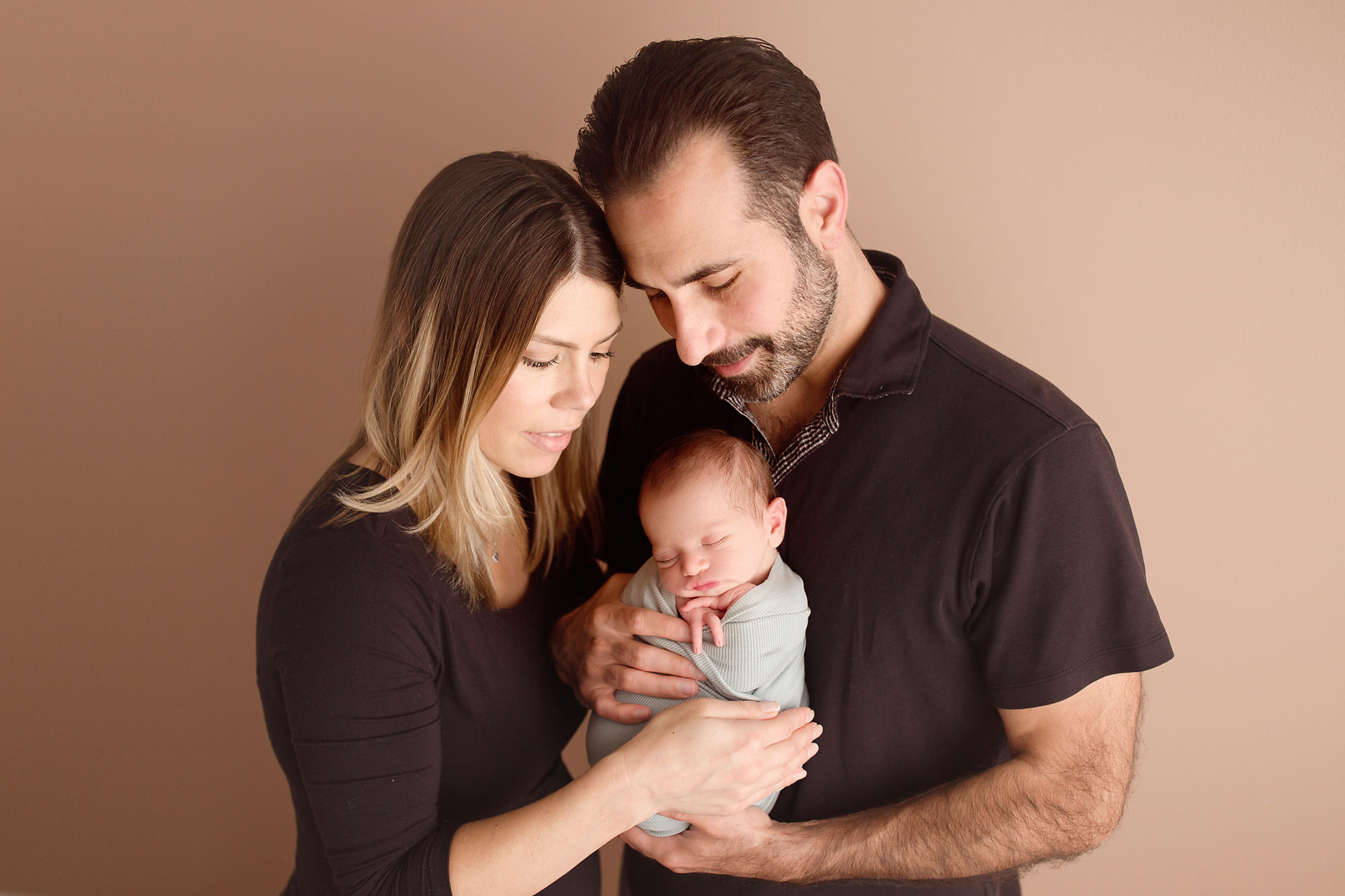 professional family and baby photos, mom and dad holding newborn baby boy 