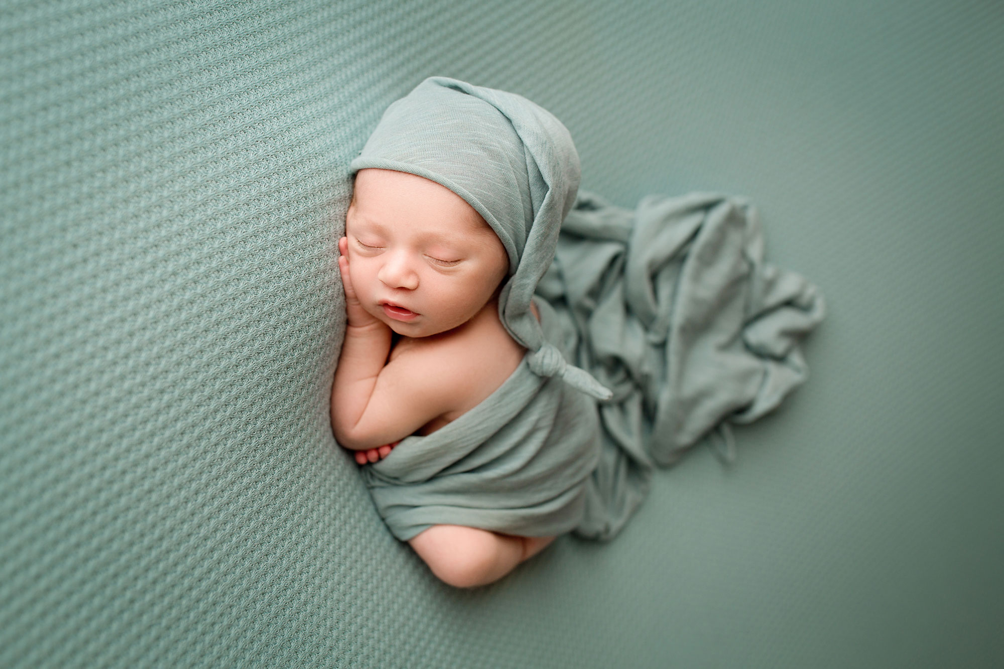branchburg professional baby photos, baby boy asleep in teal swaddle and matching cap