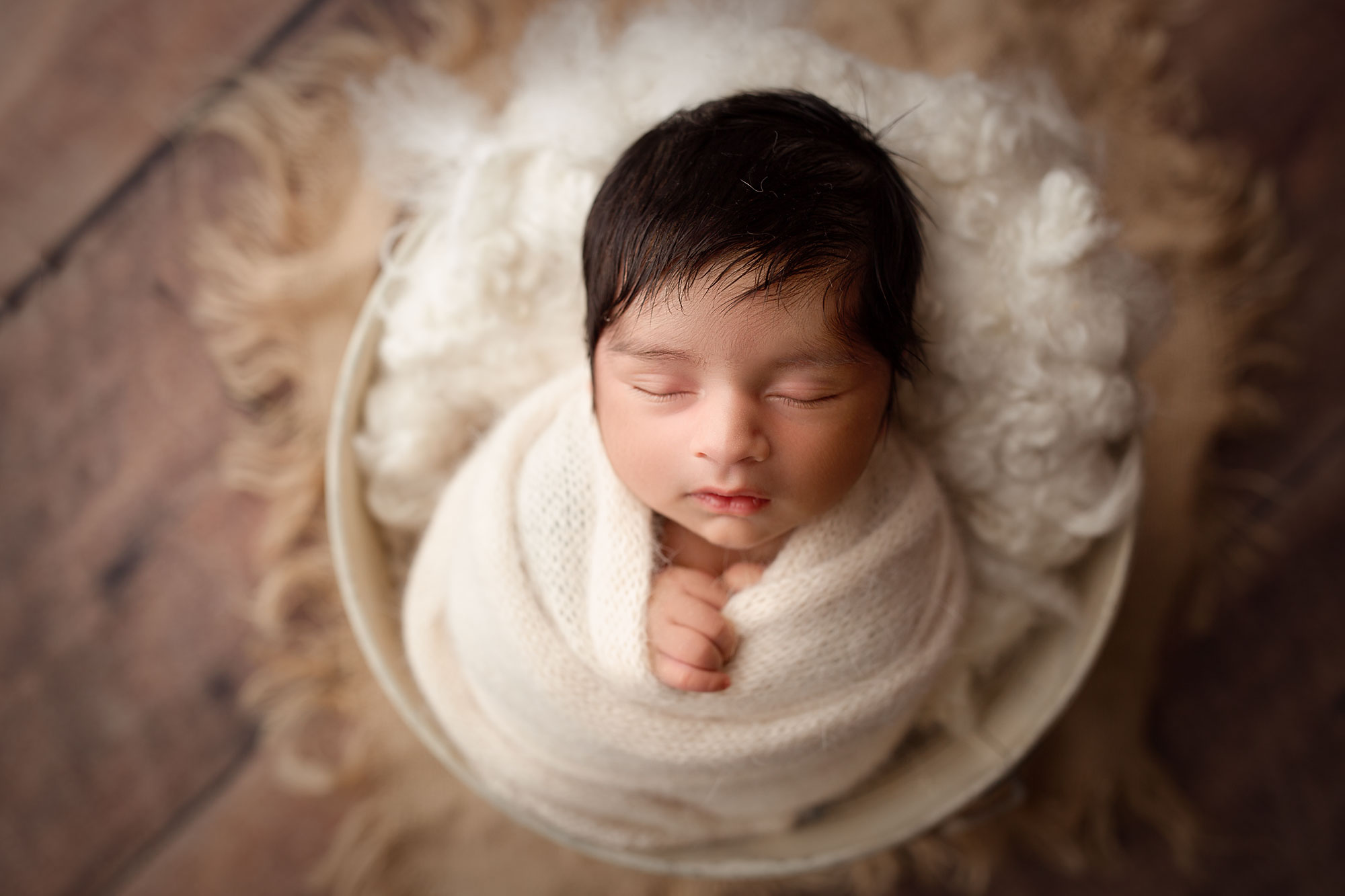 professional newborn photography session hackettstown nj, baby boy in white swaddle sleeping in bucket
