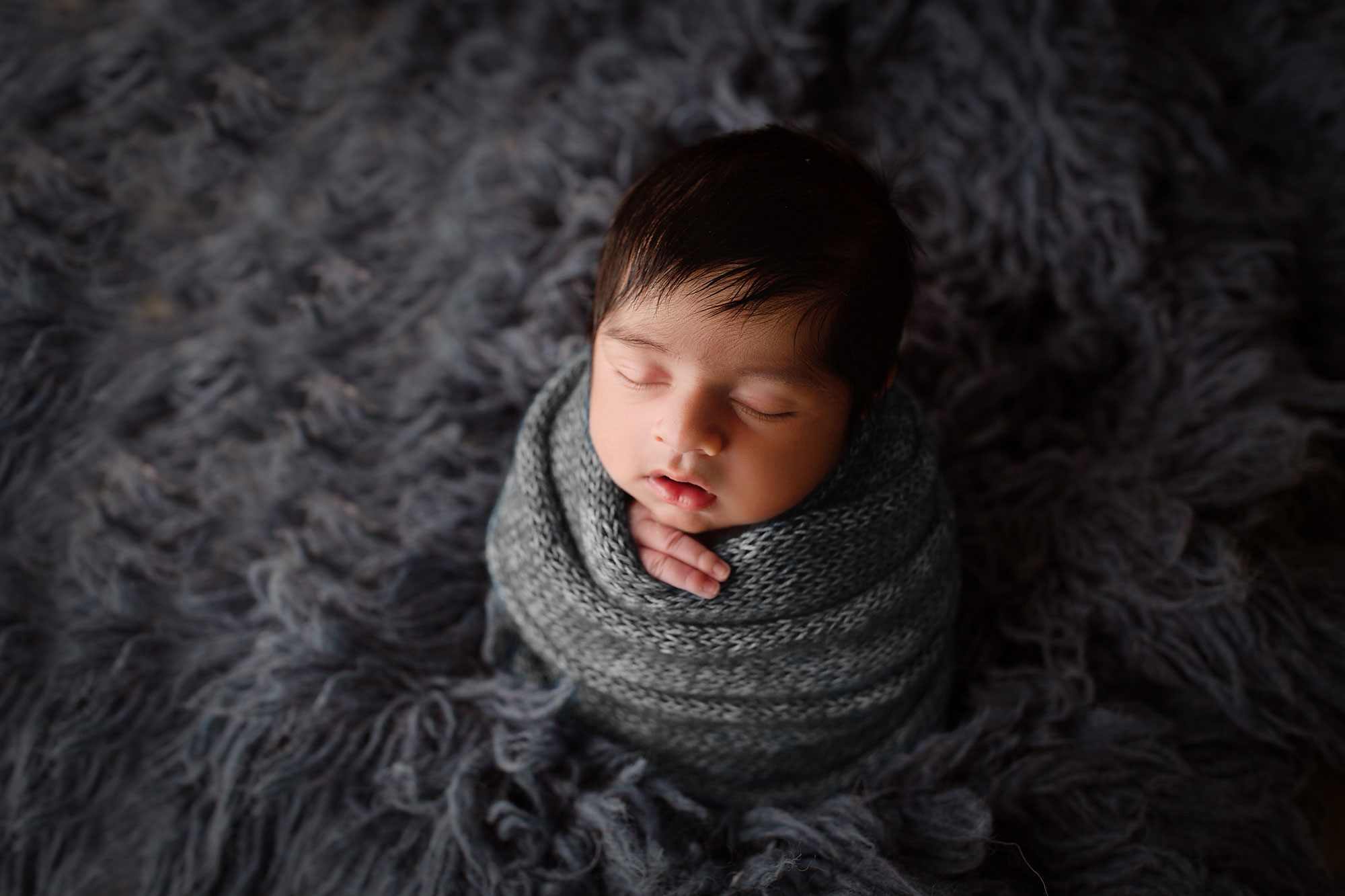 professional newborn photography nj, swaddled baby with dark gray swaddle and dark fur