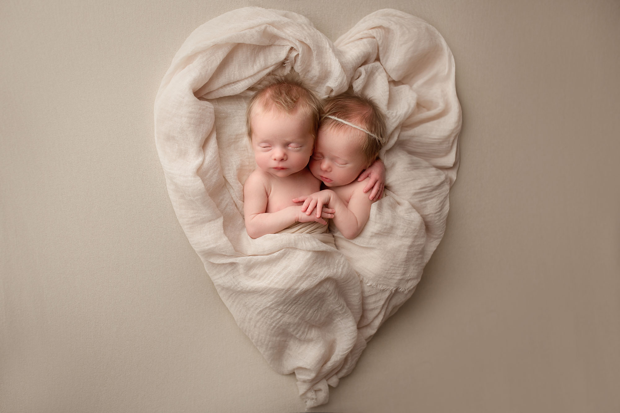 twin rainbow babies photo session, twin girls snuggled in a heart wrap Twin Rainbow Babies Photo Session