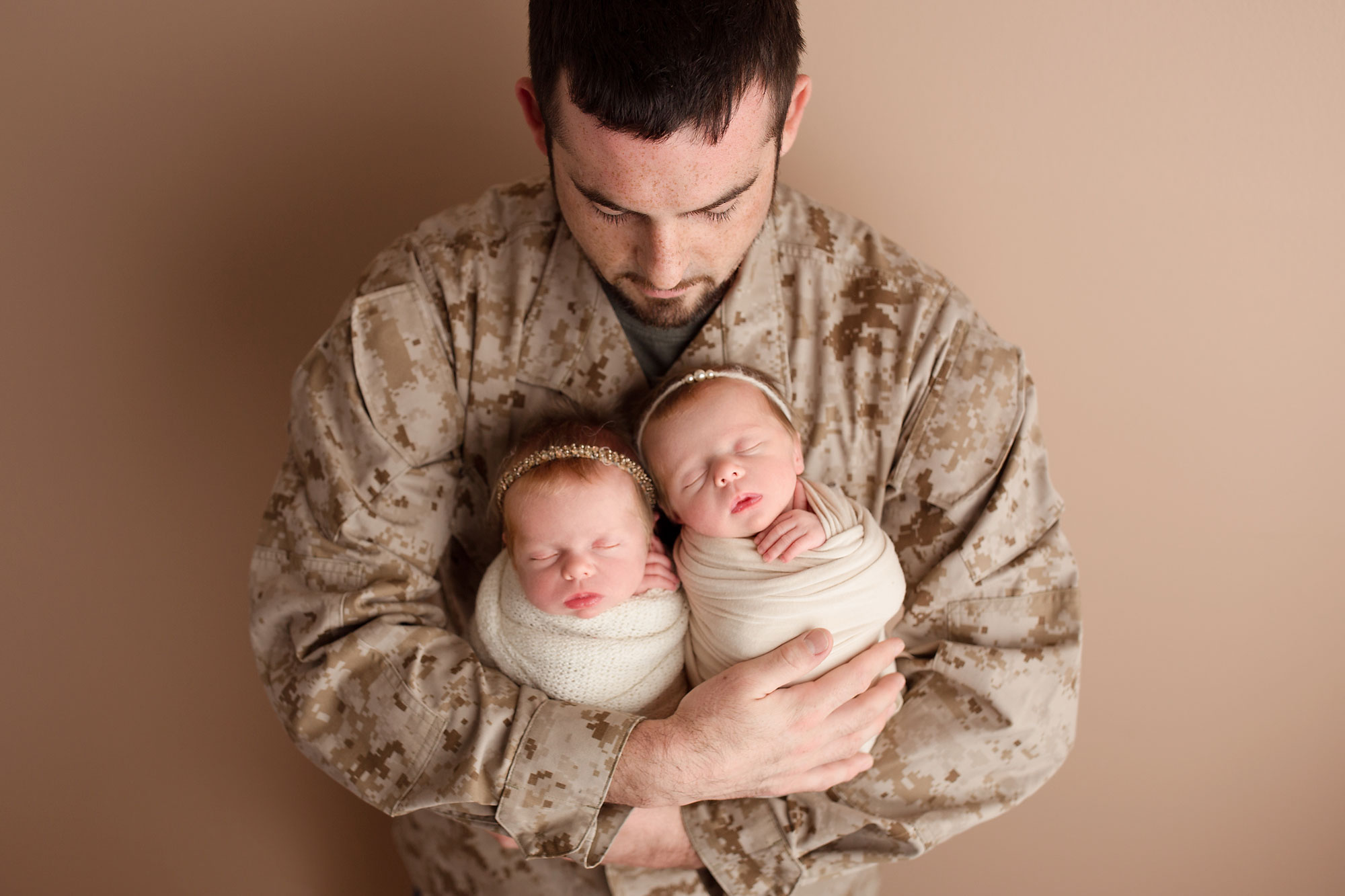 twin newborn photography new jersey, dad in uniform holding twin baby girls