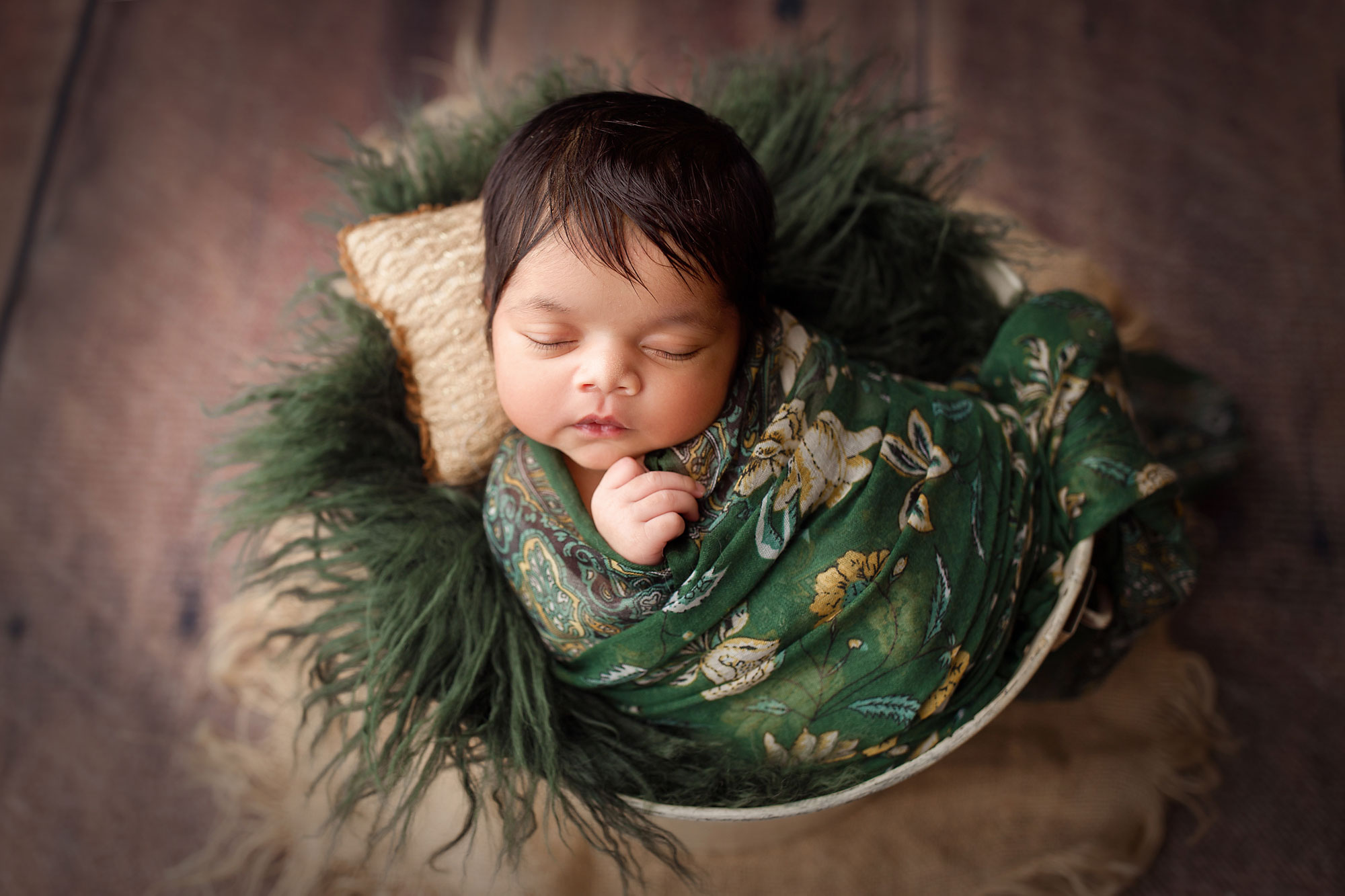 baby photographer bergen county nj, baby sleeping in bucket with green fur and floral wrap
