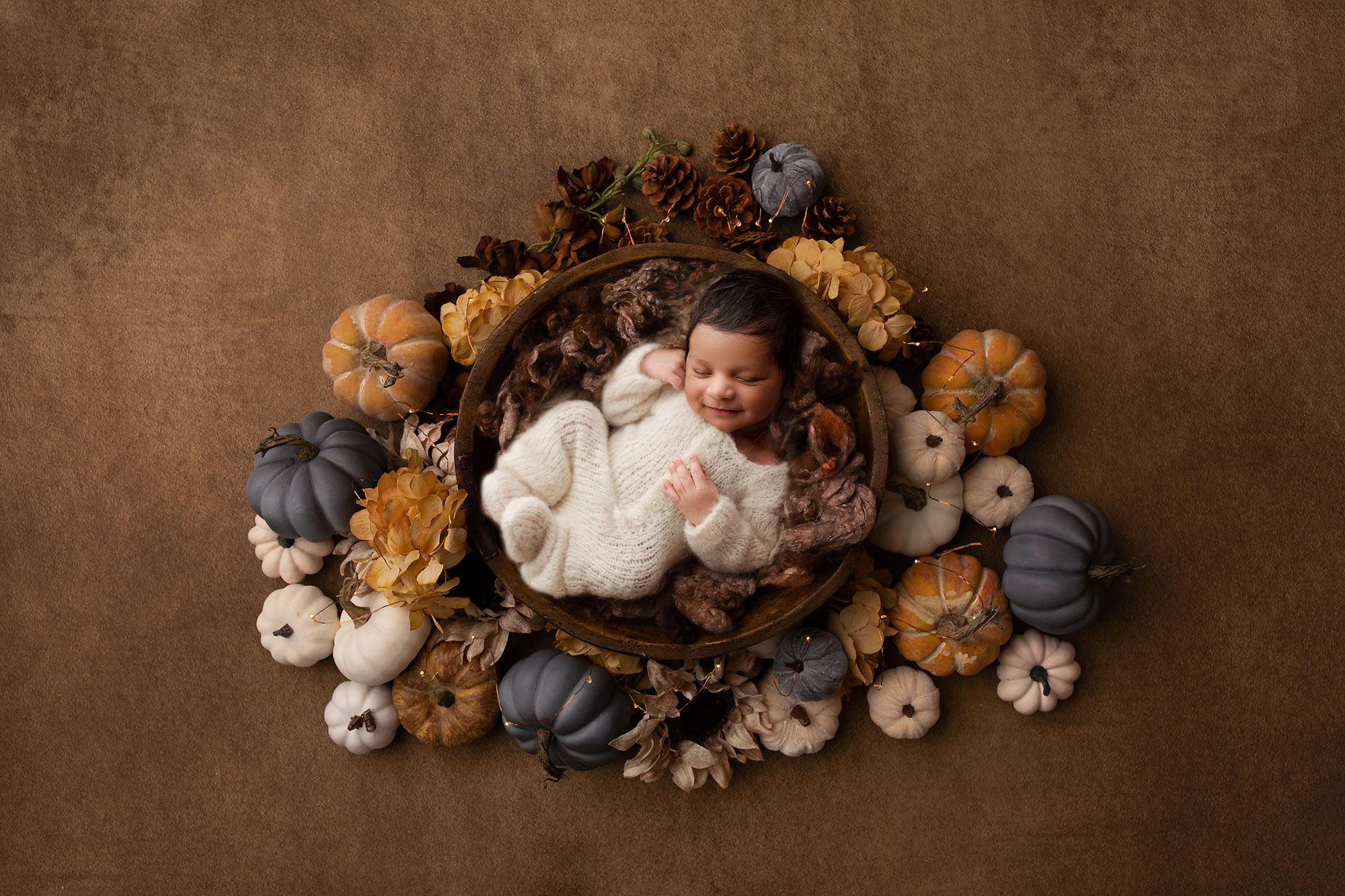 creative newborn photography new jersey baby boy in a floral wreath pumpkins