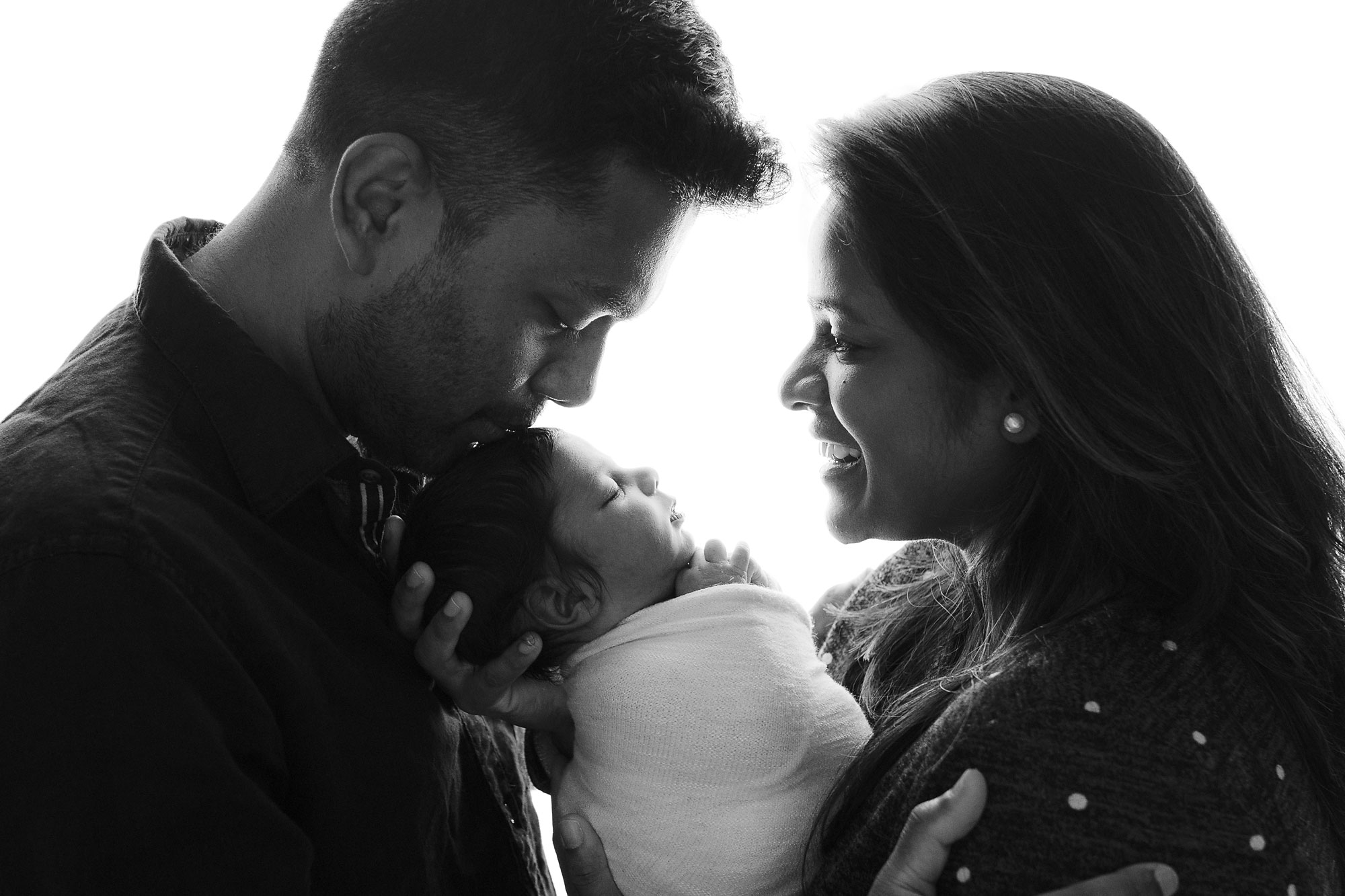 newborn photographer lehigh valley, black and white image of mom and dad holding newborn