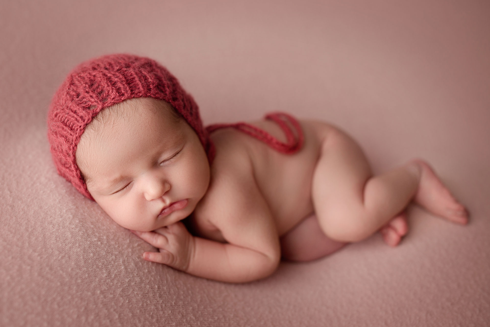 baby in a bonnet photographed by hudson county nj photographer 