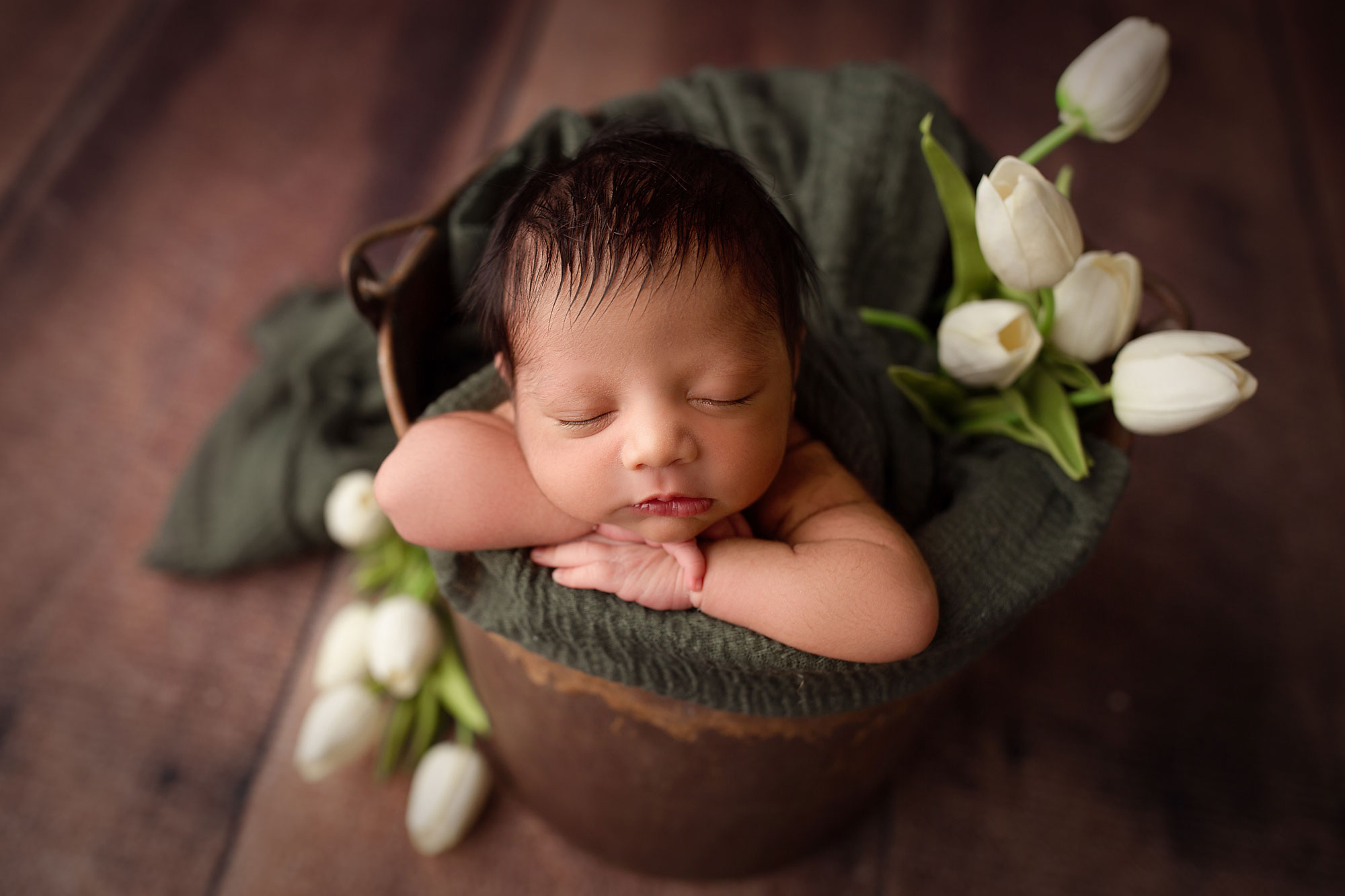 newborn photography studio nj, baby asleep in bucket with white flowers