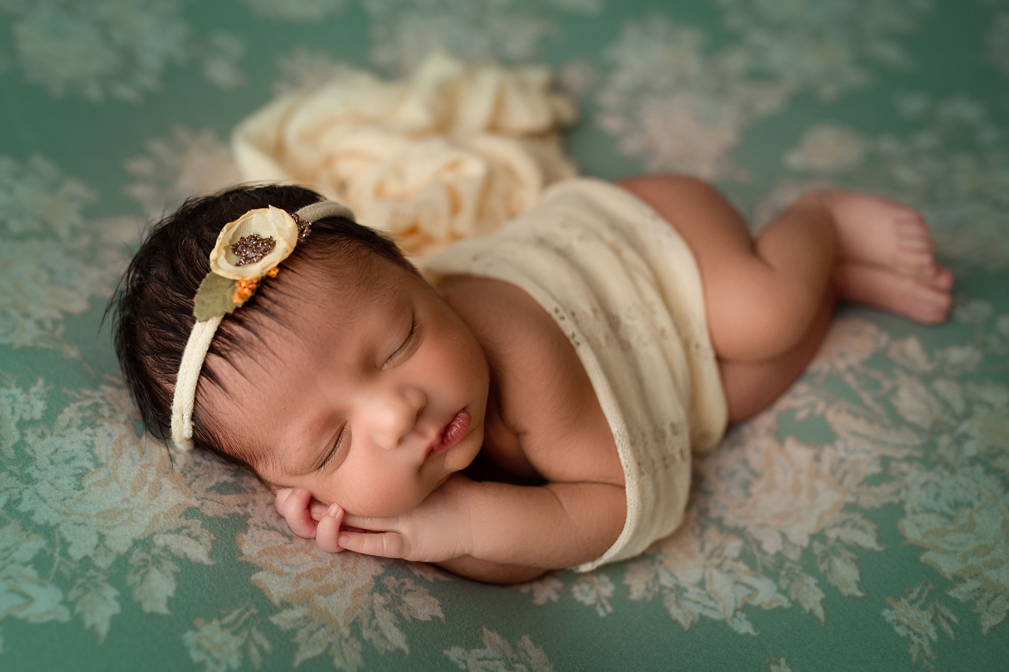 baby photos hunterdon county nj, baby girl in cream wrap sleeping on floral and teal backdrop