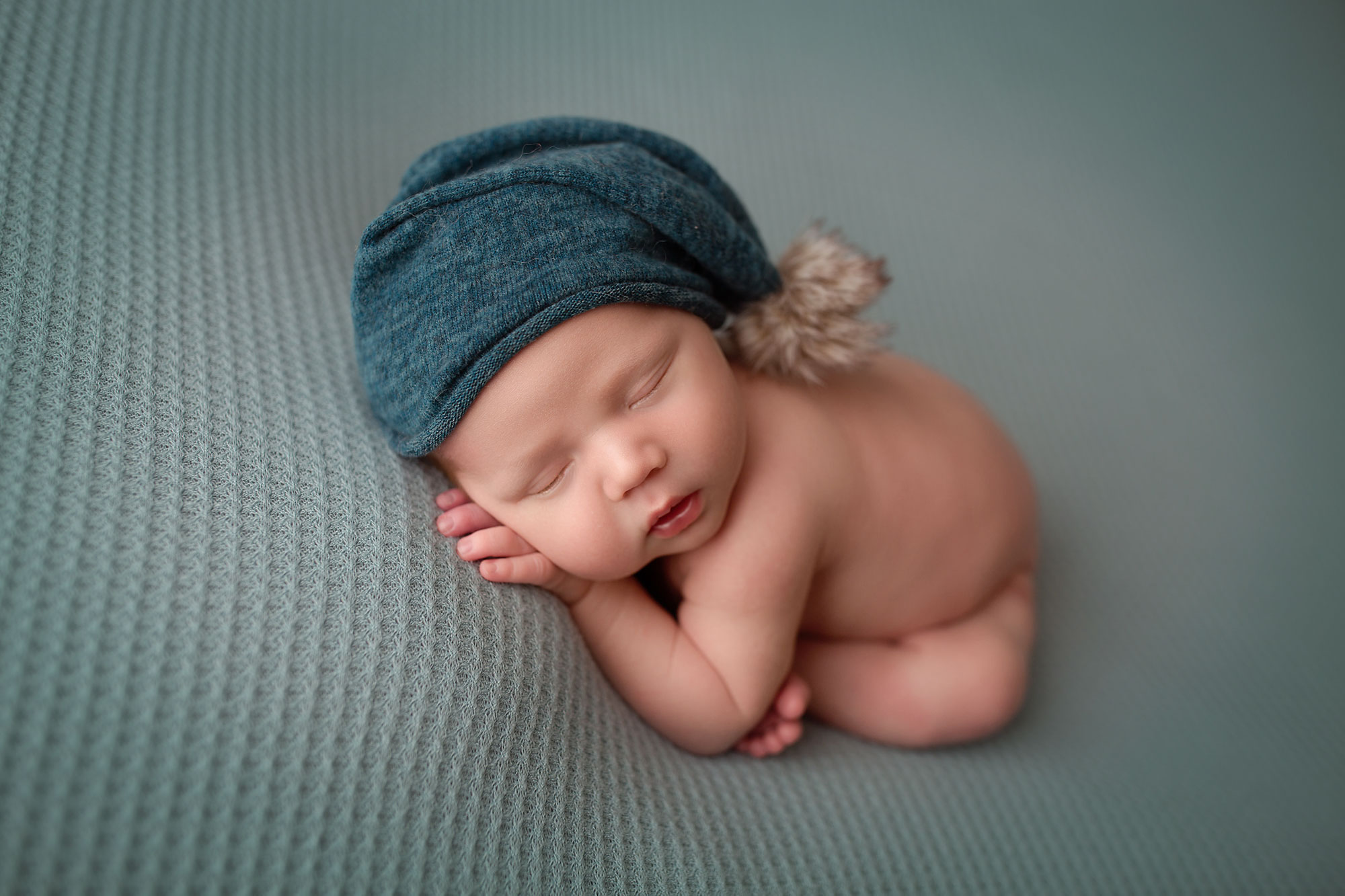 annandale nj newborn photographer, baby boy with blue cap curled up sleeping