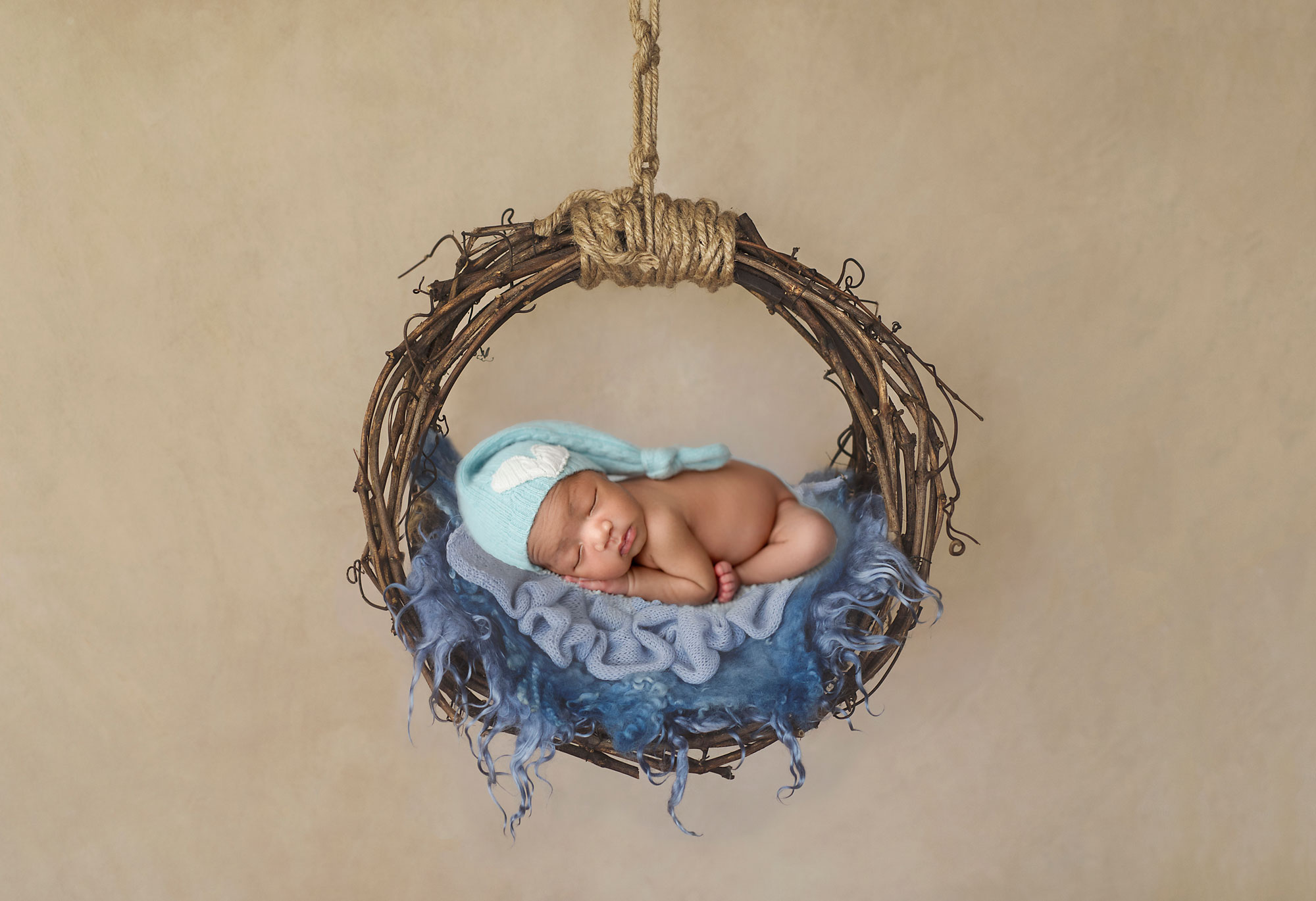 pa photographer, newborn infant in blue asleep on wooden wreath