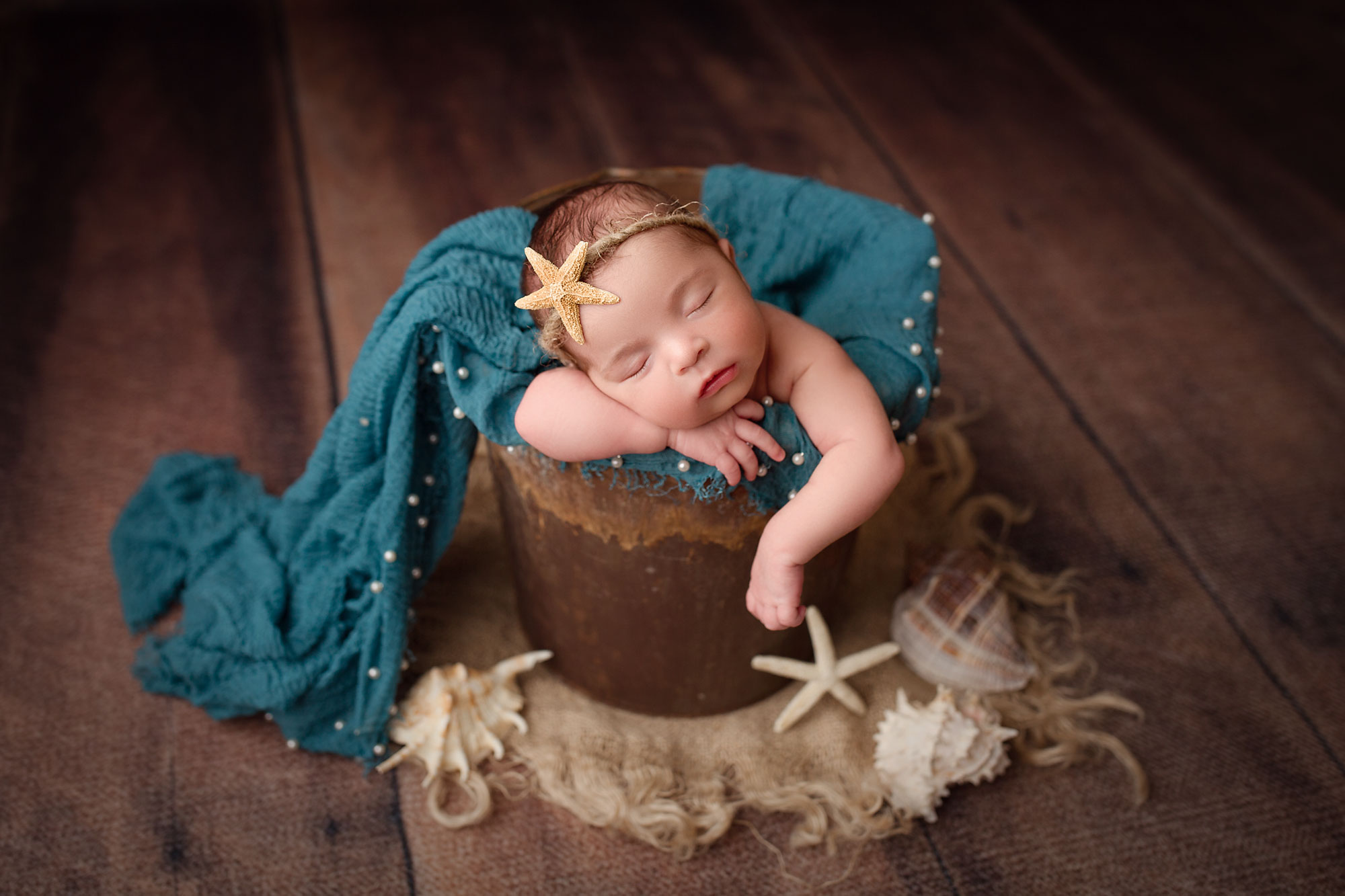 baby girl newborn photo session new jersey, baby asleep in bucket with seashells and blue pearl blanket