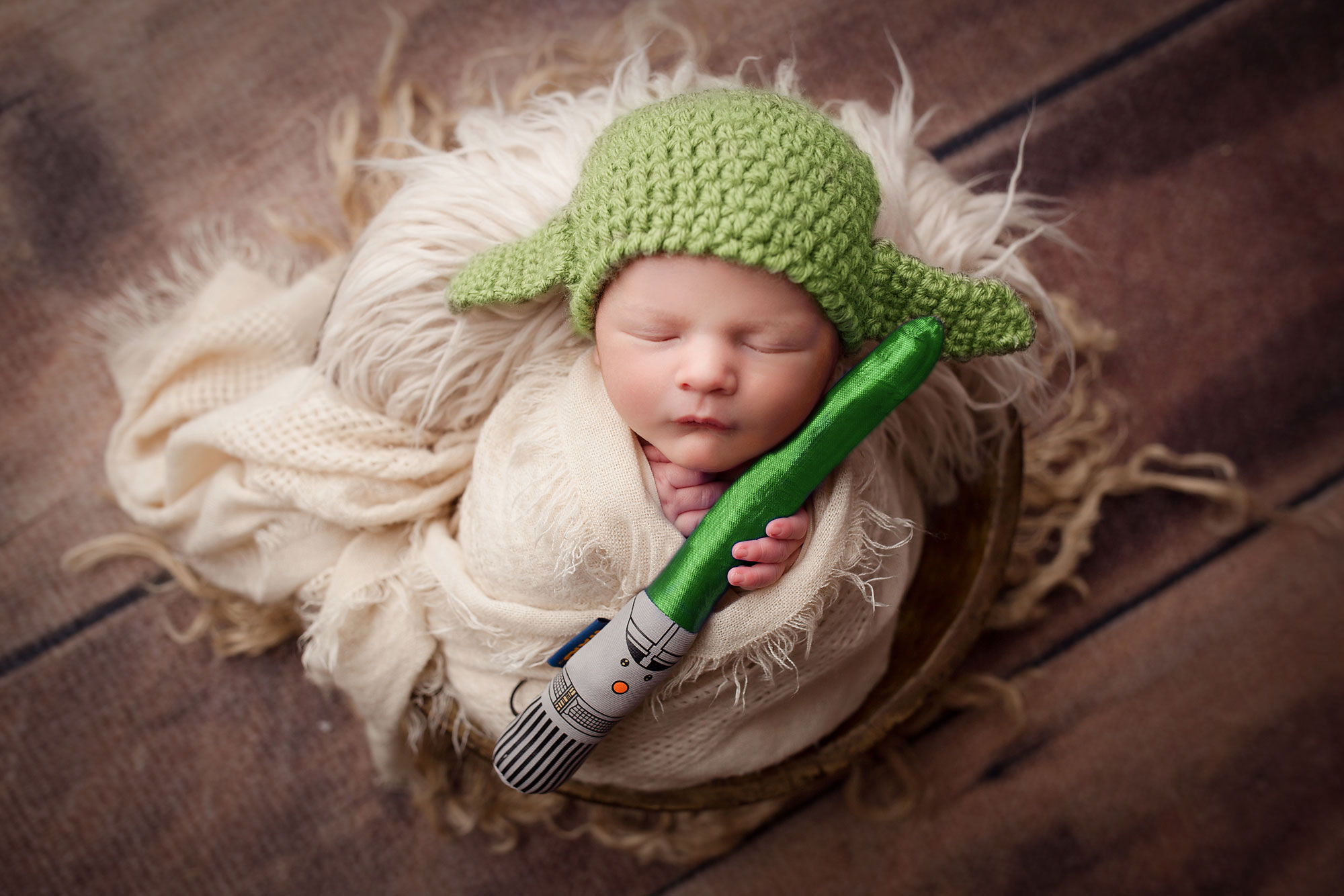 star wars baby pics, baby in yoda hat holding light saber