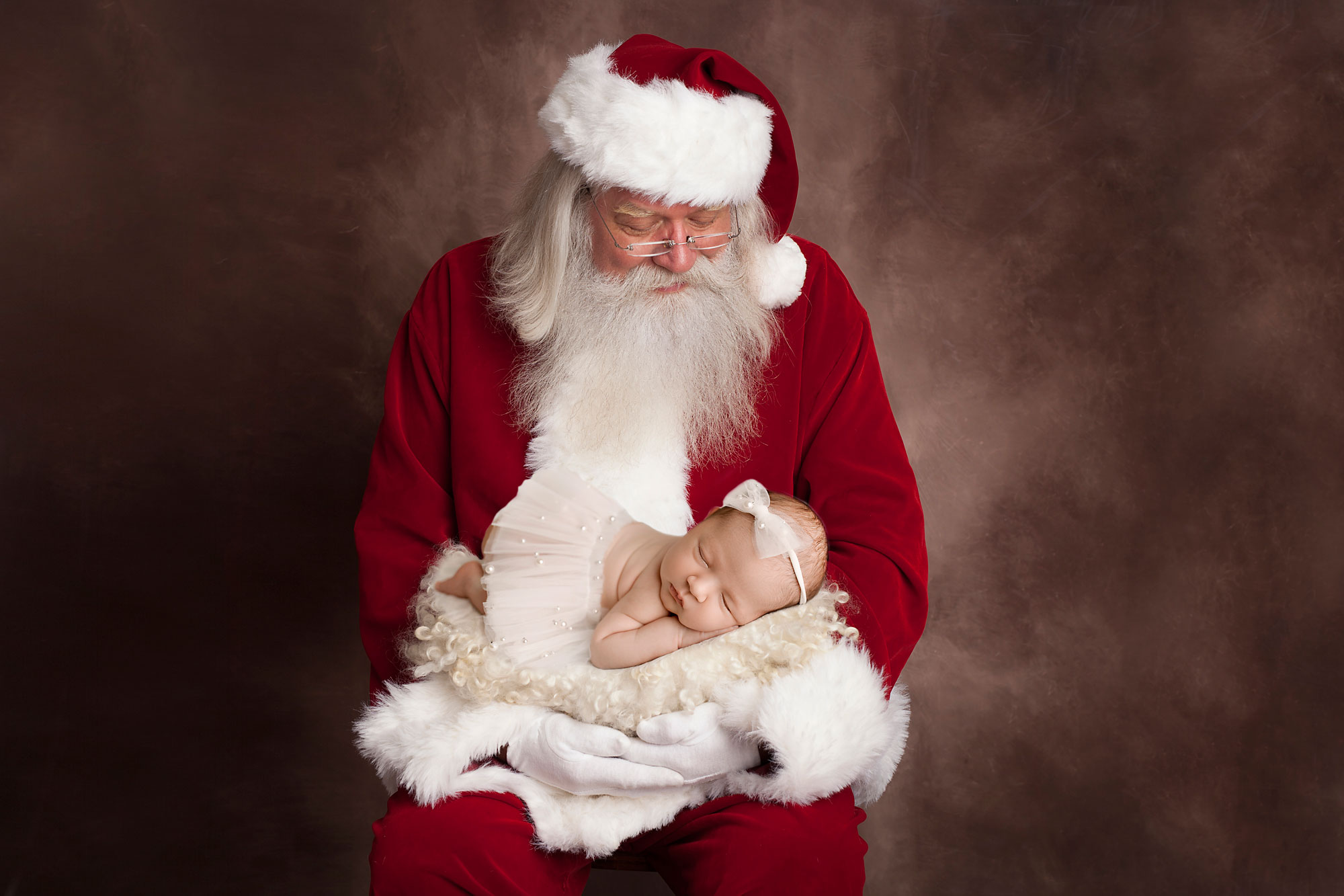 newborn baby girl in a basket help by santa clause