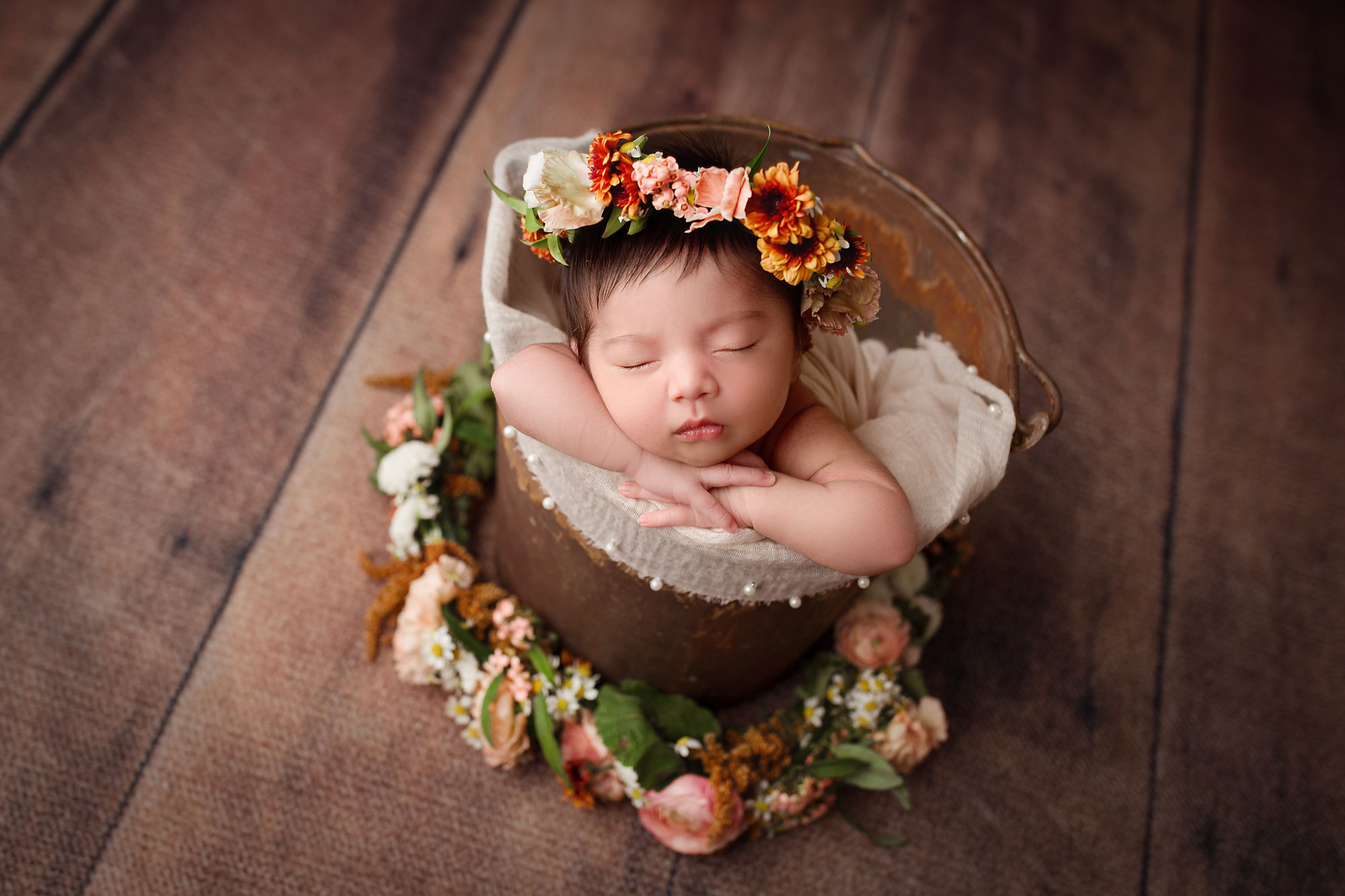 newobrn baby girl wearing a fresh flower crown 