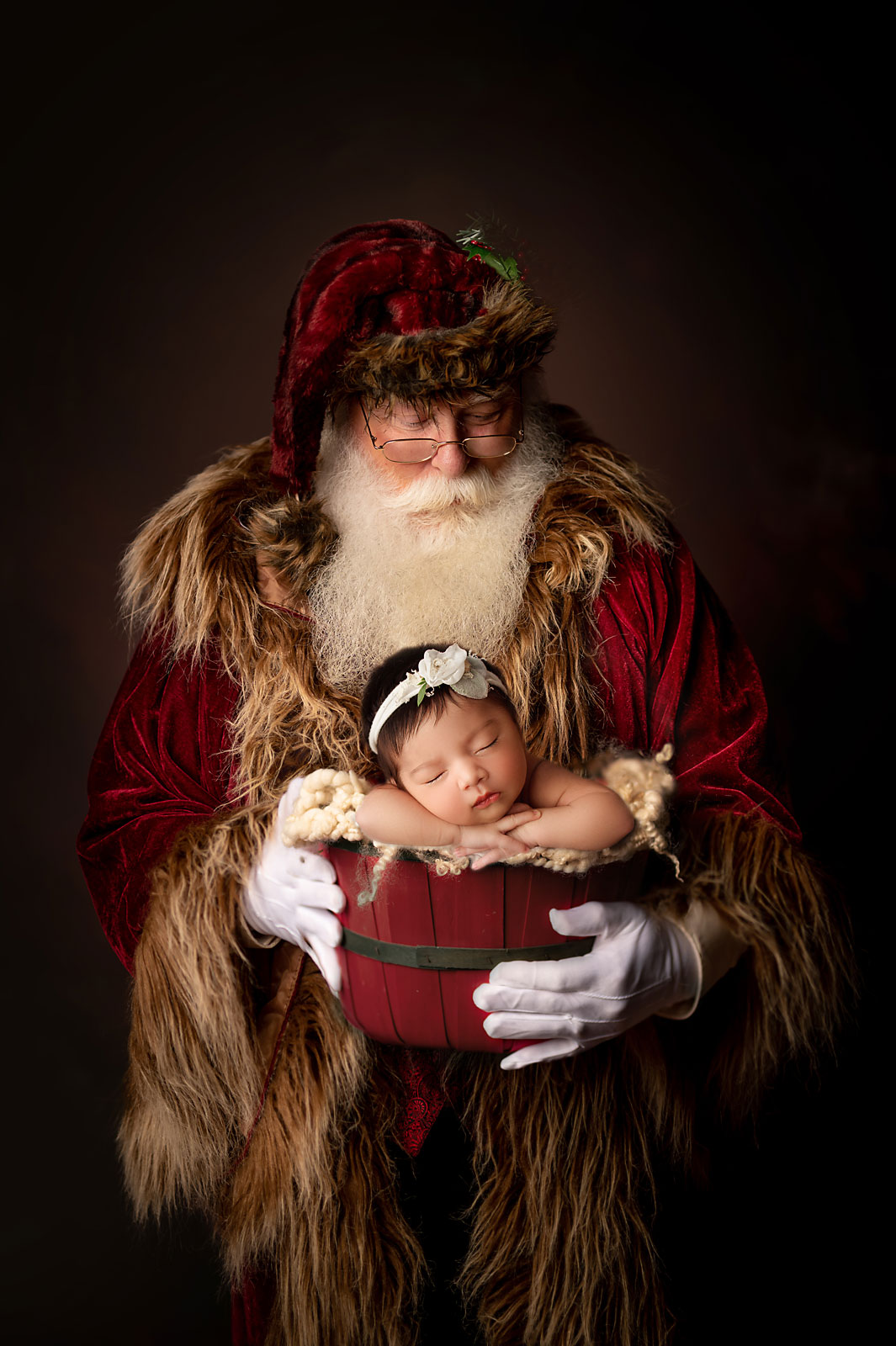 newborn baby girl in a basket help by santa clause
