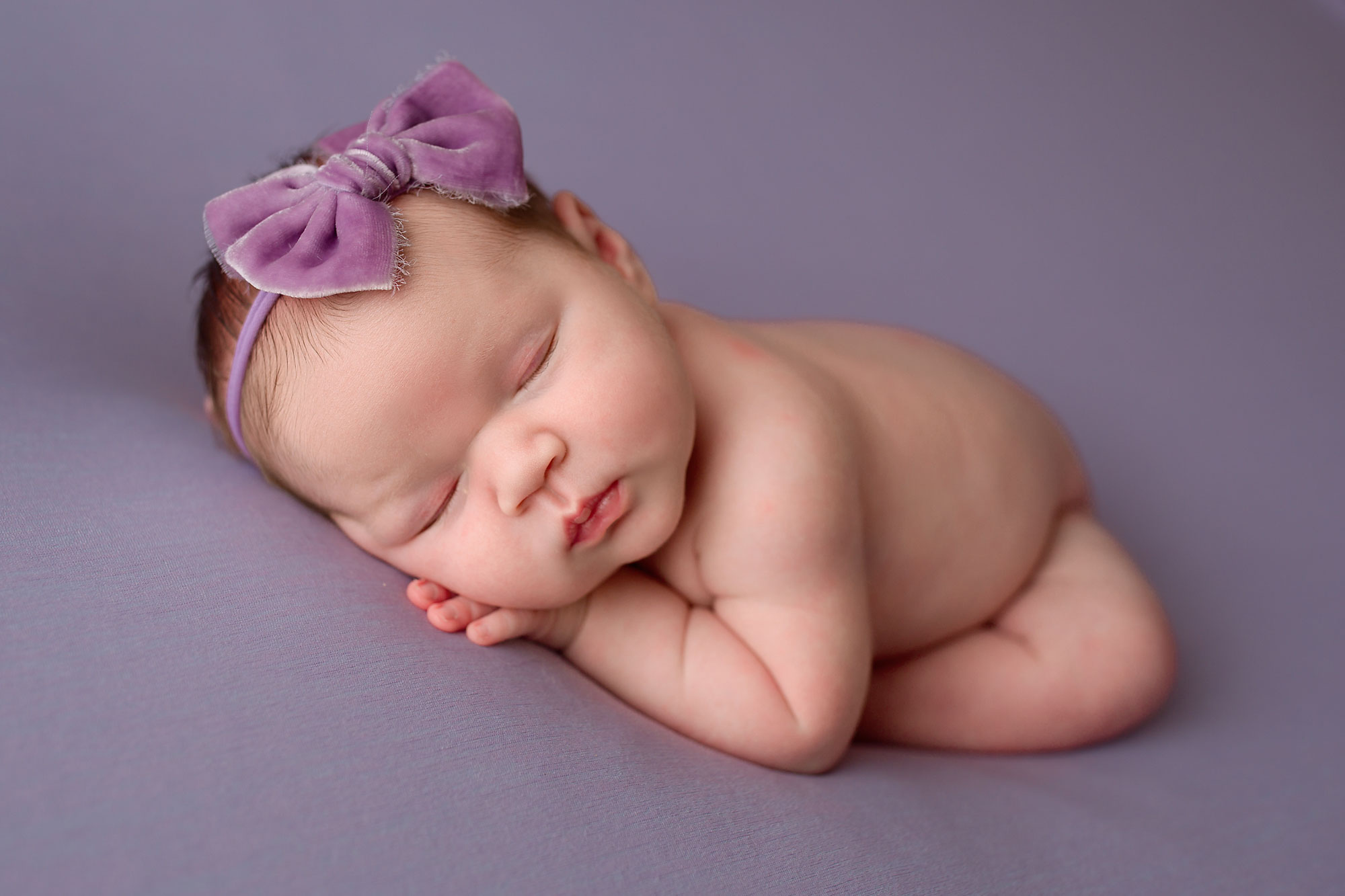 newborn baby girl sleeping on a blanket during her essex county nj newborn photo session