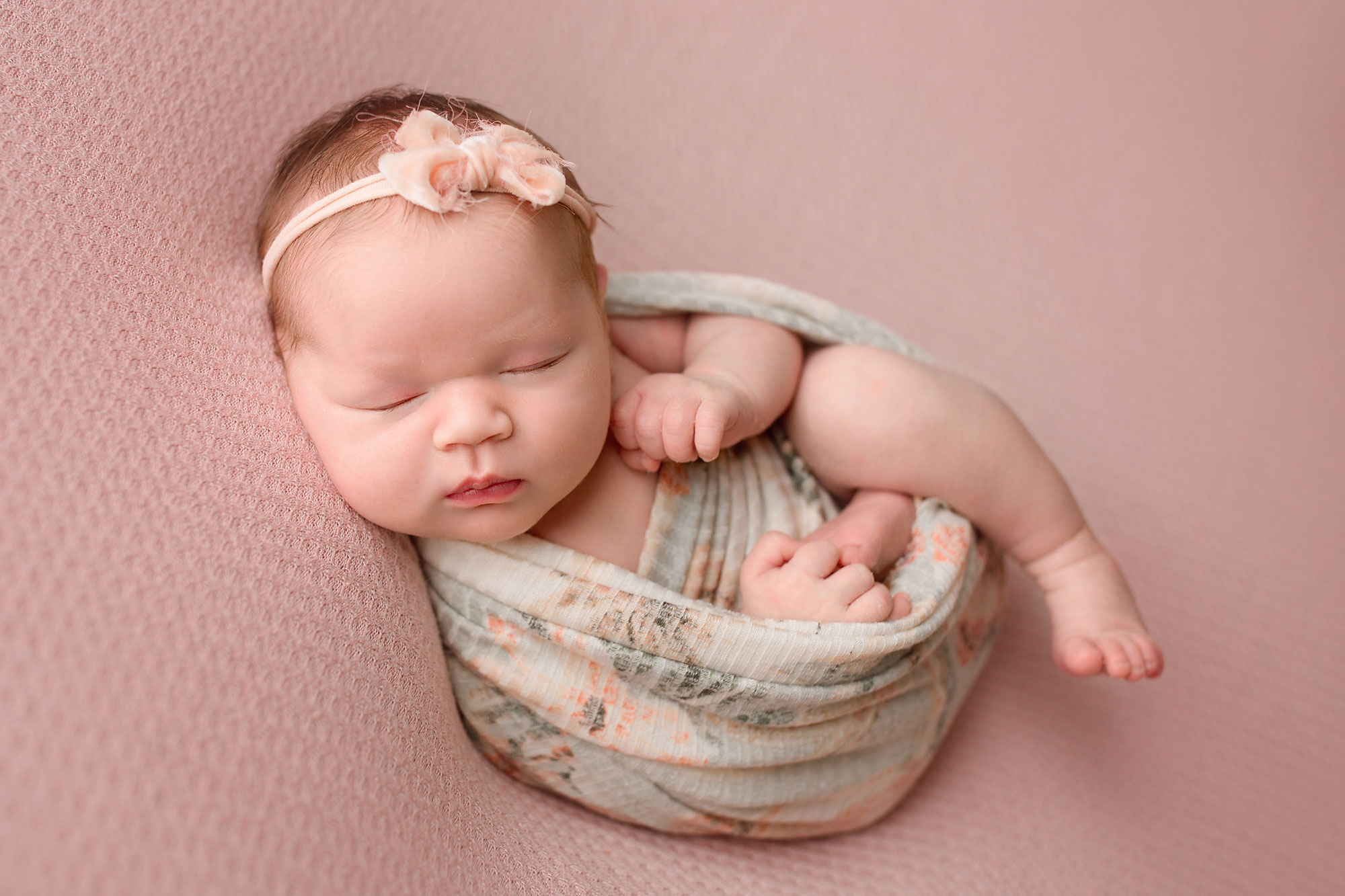 newborn baby girl sleeping on a blanket during her essex county nj newborn photo session 