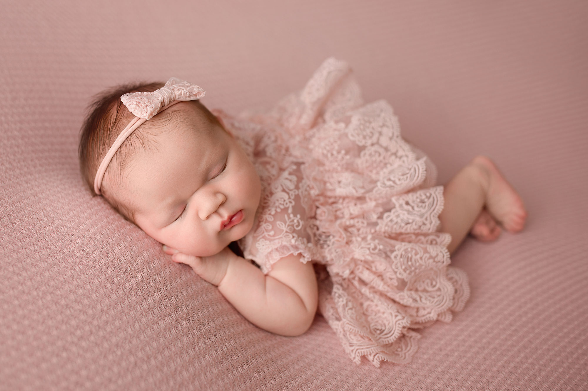 newborn baby girl sleeping on a blanket during her Newborn Baby Photos in Essex County NJ