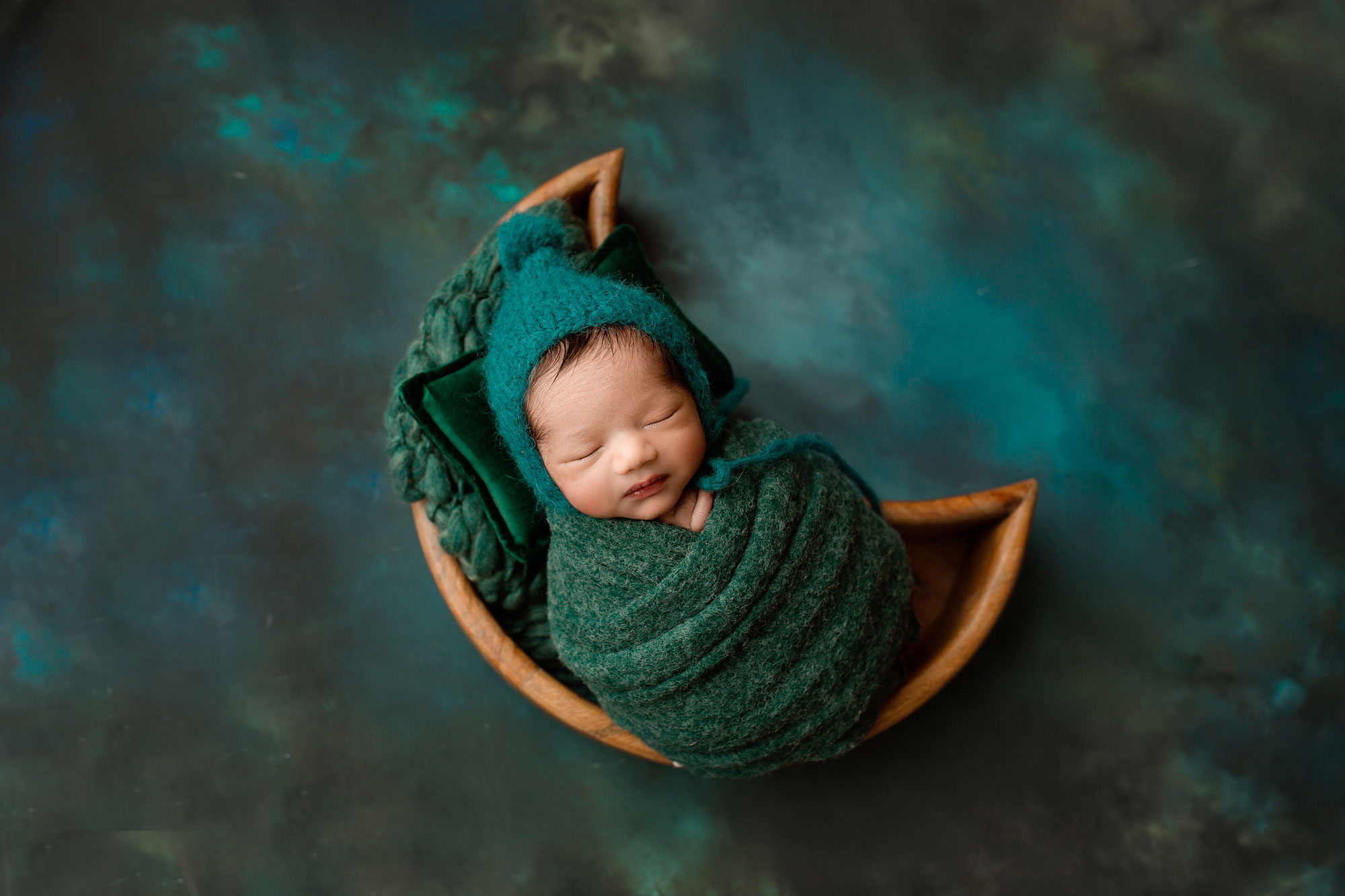 baby boy sleeping during his Hunterdon county NJ newborn session in a moon basket