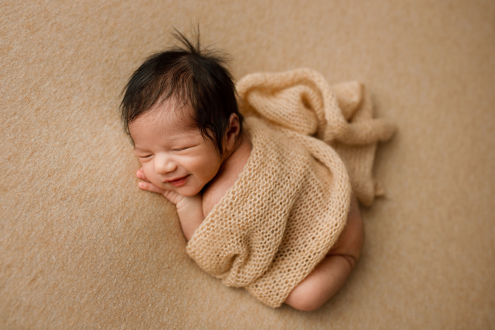 baby boy sleeping during his Hunterdon county NJ newborn session smiling 