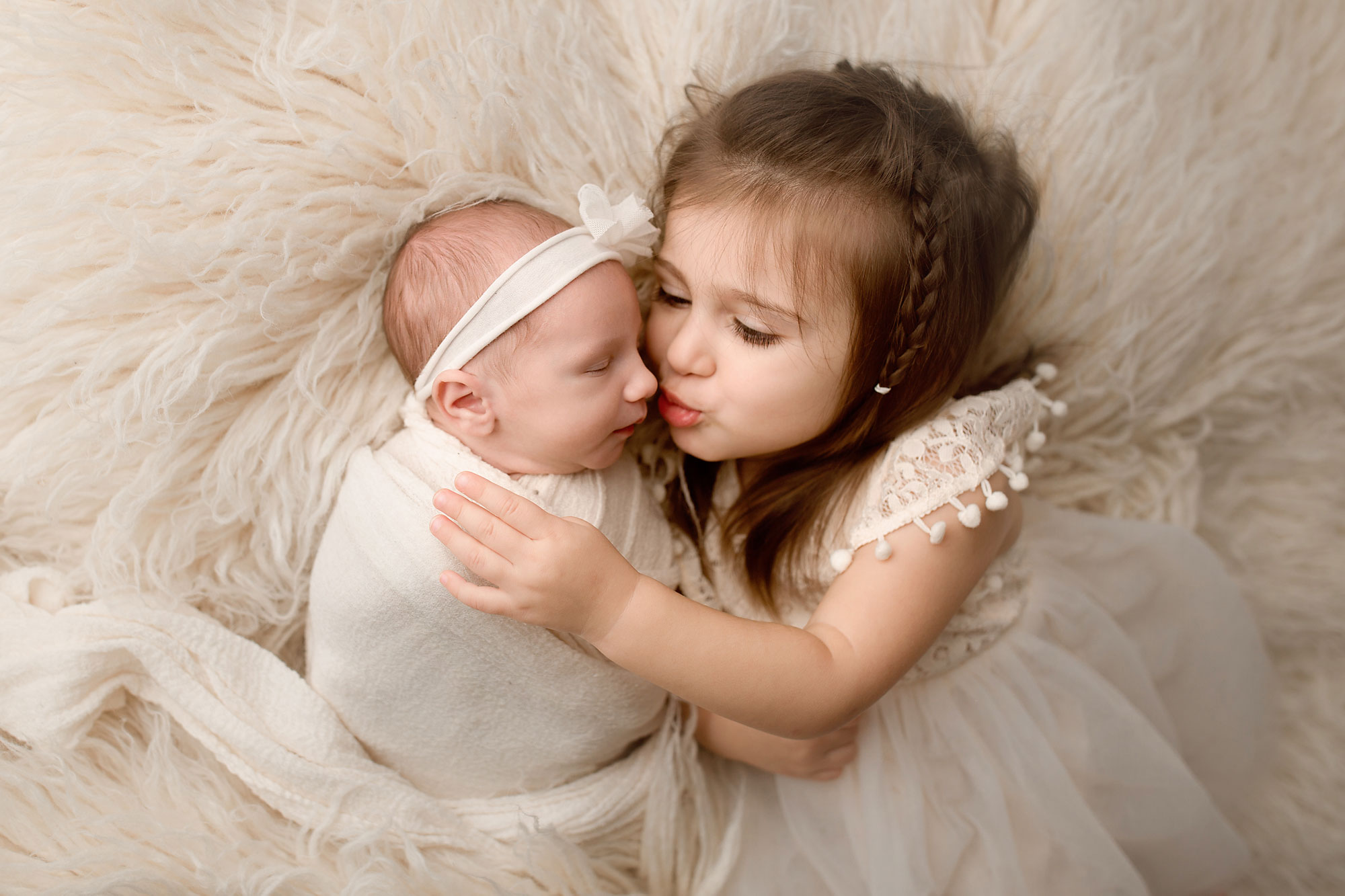baby girl with her bog sister Why Hire A NJ Professional Newborn Photographer?