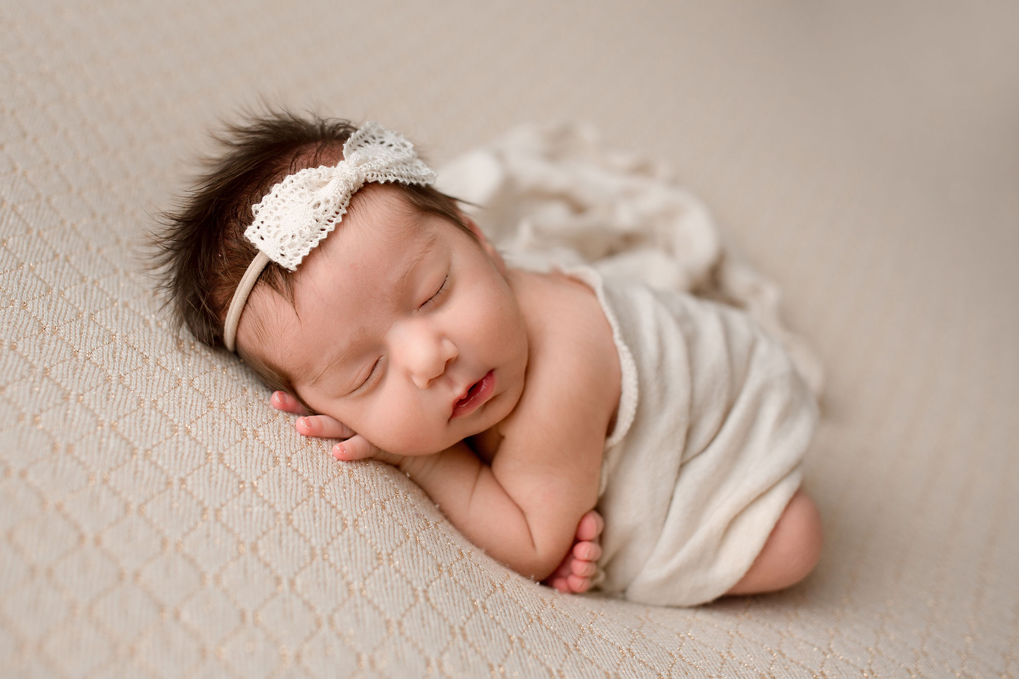 NJ newborn photographer capturing baby girl sleeping on a white blanket