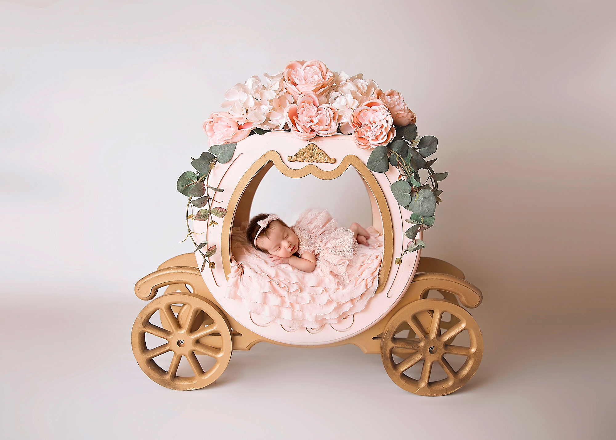 NJ newborn photographer capturing baby girl sleeping in a princess carriage