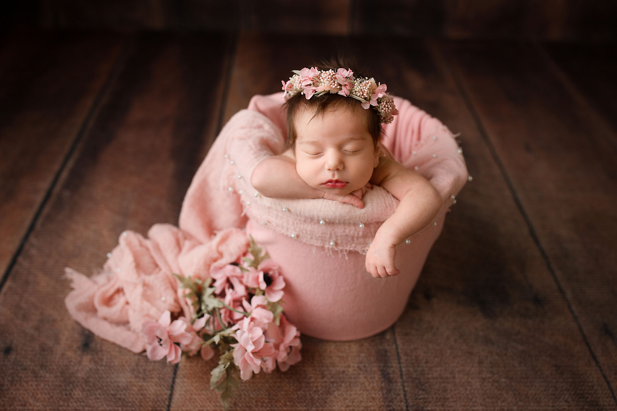 NJ newborn photographer capturing baby girl sleeping in a bucket