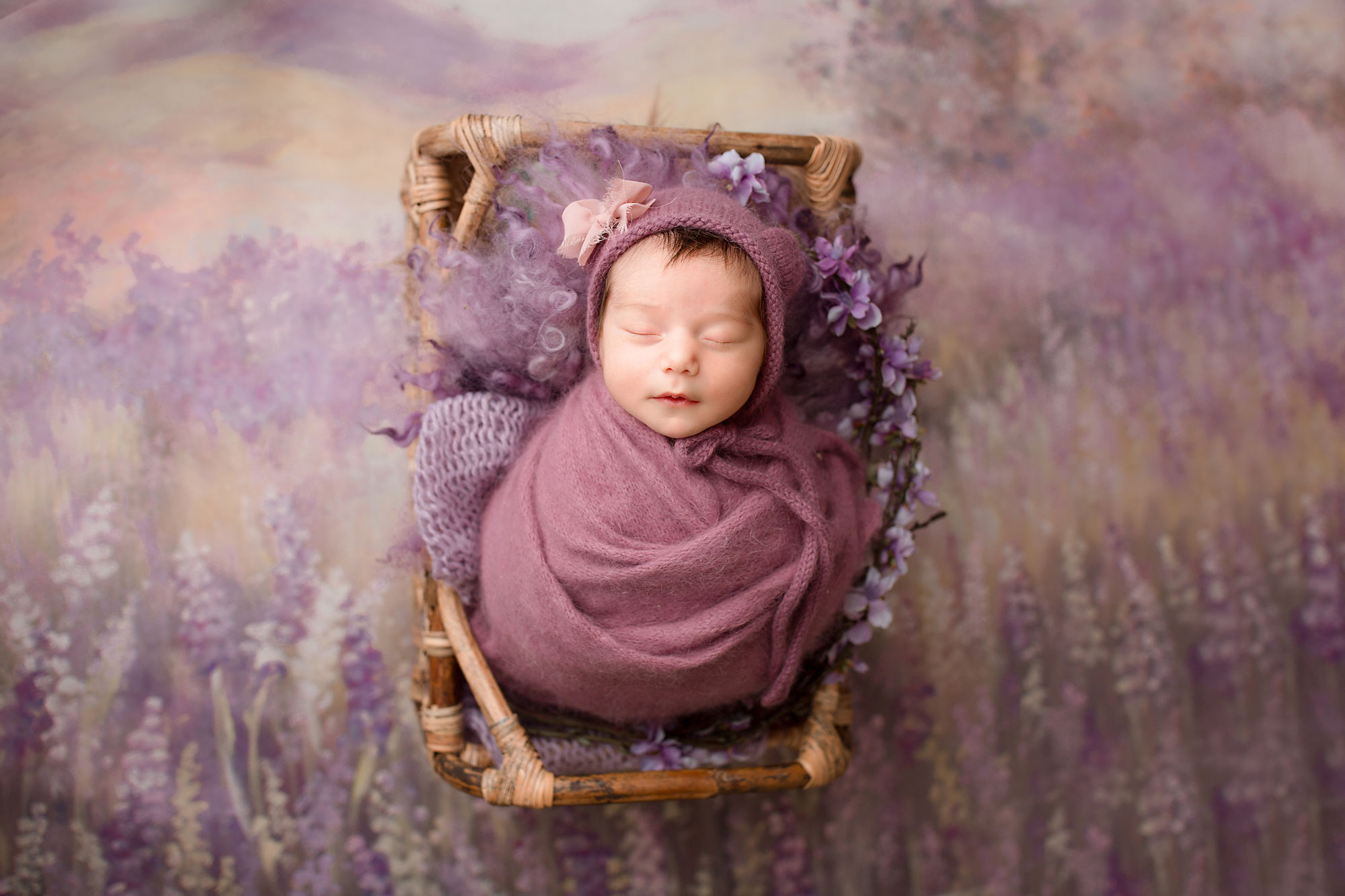 NJ newborn photographer capturing baby girl sleeping in a wooden bed