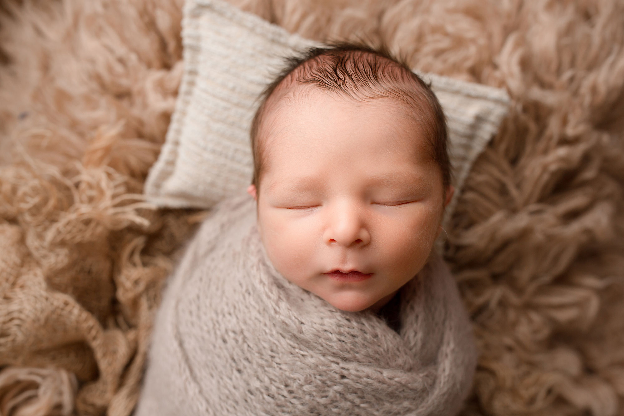 baby boy in on a rug during his Chester NJ newborn photography session 