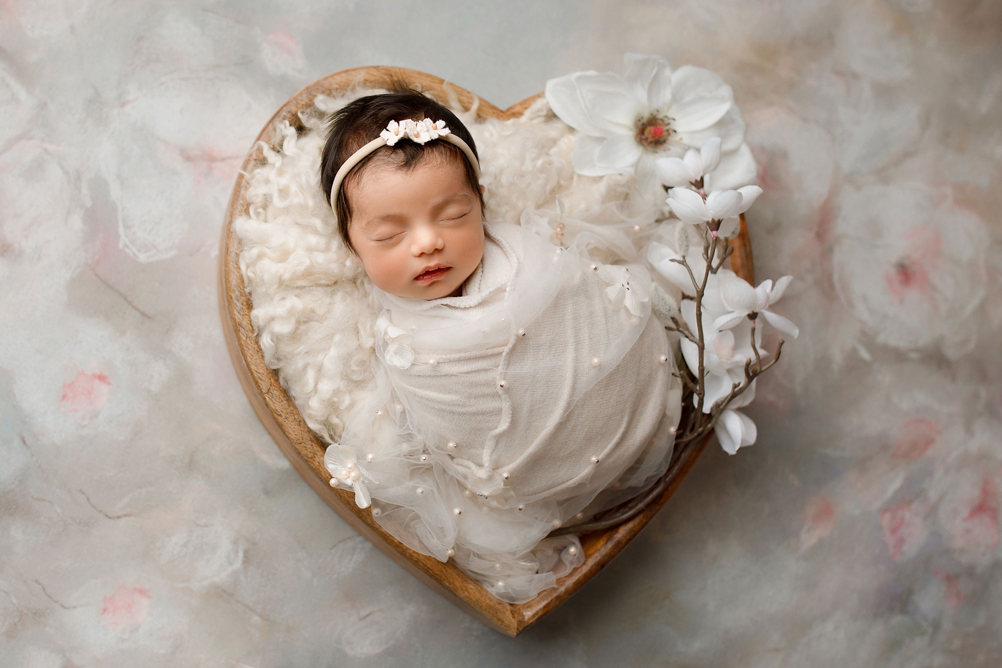 baby sleeping in a basket for newborn photos