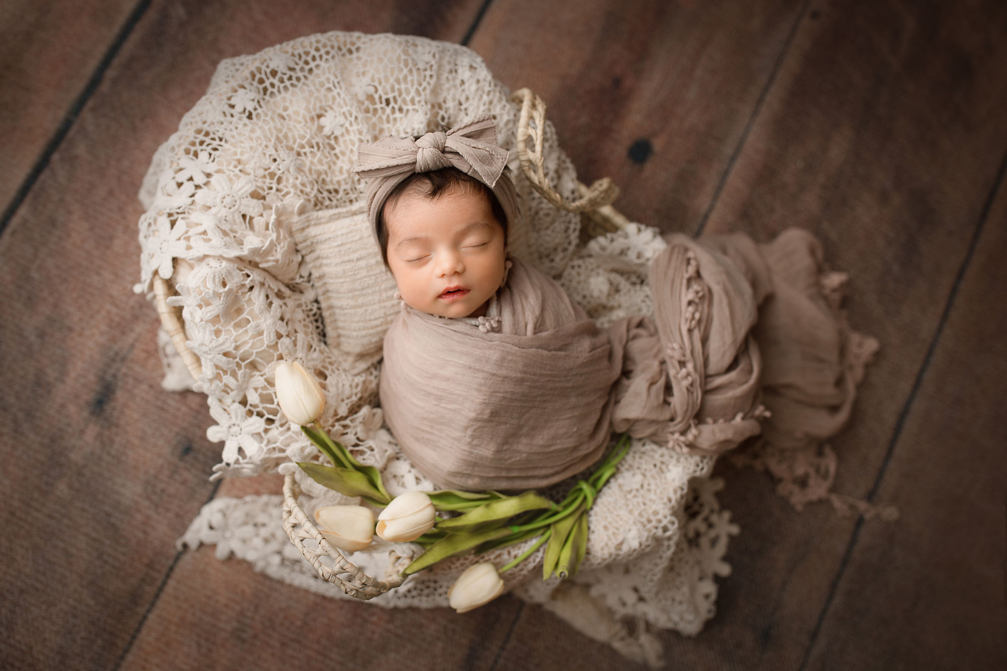 baby sleeping in a basket for newborn photos 